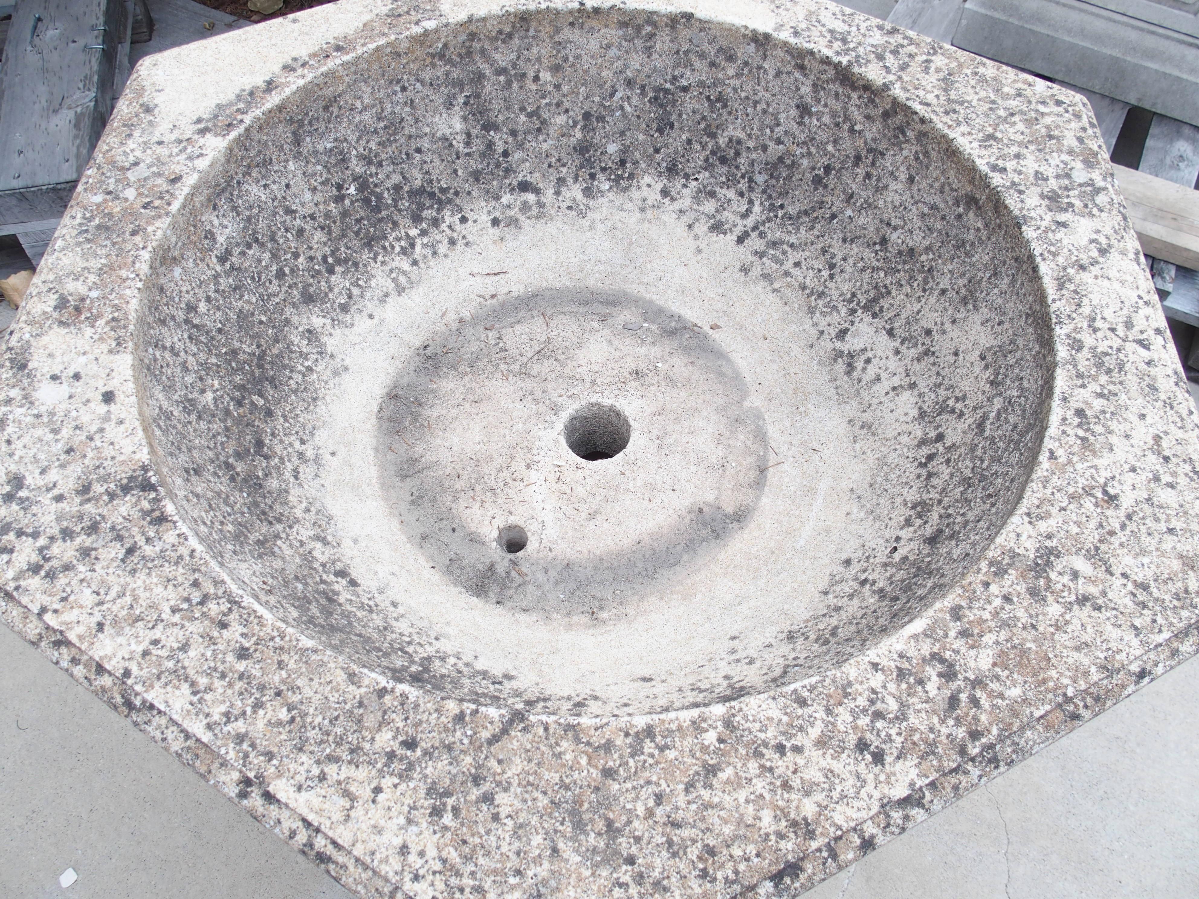 Hailing from Aix-en-Provence in the South of France and dating to the 1900s, this fountain element was cast in four sections. The soft cream-color has developed a mottled patina of brown, black, and gray on the basin, while the angular column has