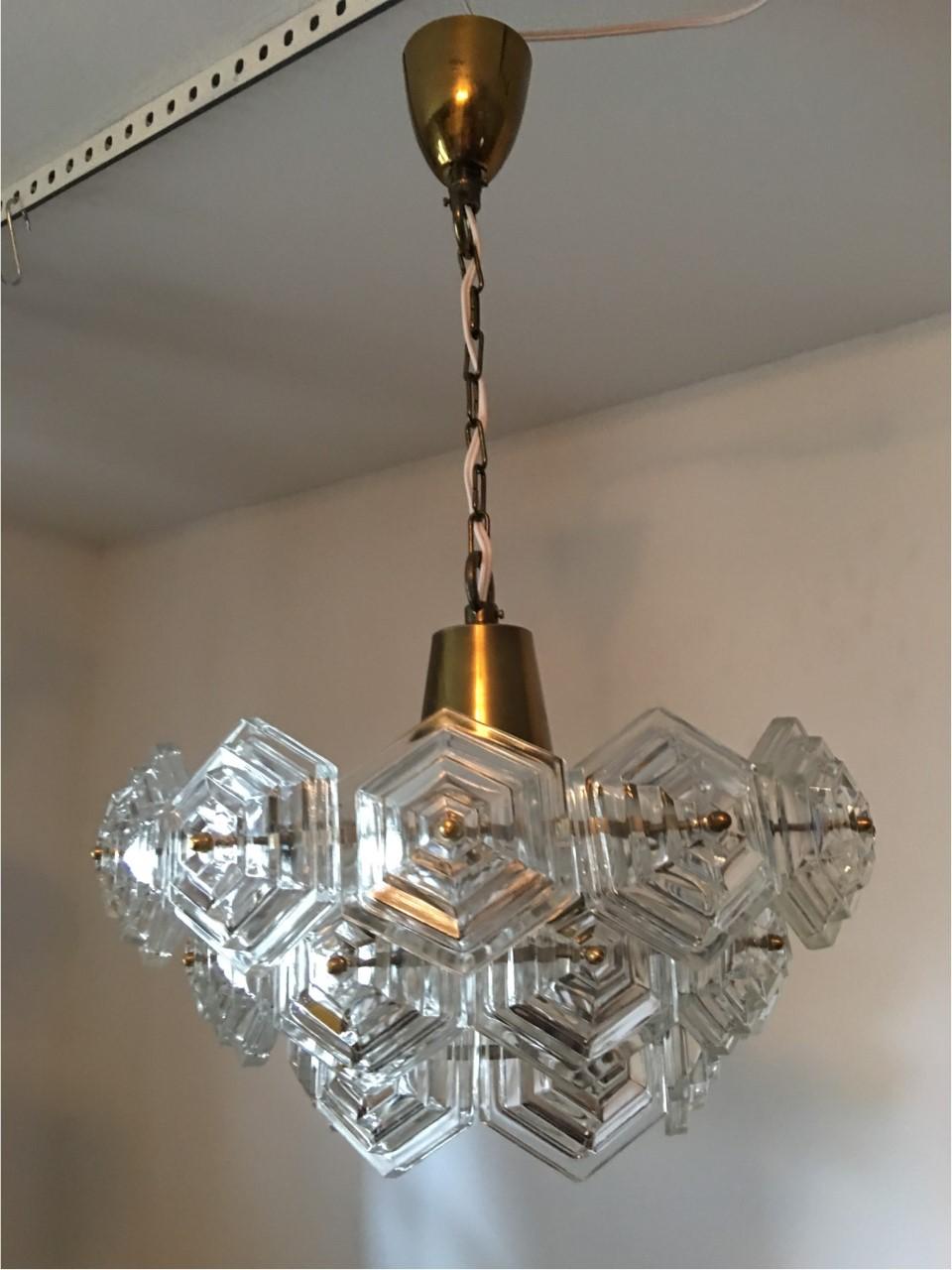 Chandelier with hexagonal glass crystal hanging from a brass chain, 1970s, Germany. The fixture requires one European E 26 / E27 Edison bulb, bulb up to 60 watts. Rewired to meet U.S. standards.