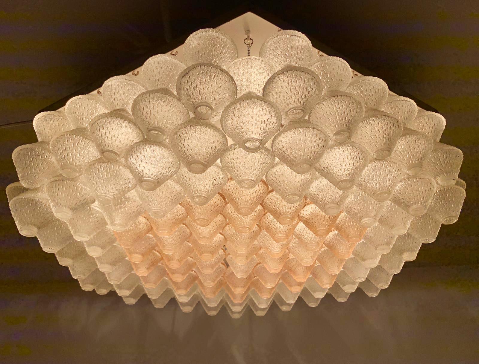 Vintage Italian flush mount with clear and pink textured Murano glass elements suspended on white frame / Made in Italy by Venini, circa 1960s
Measures: diagonal distance 27.5 inches, side width 16 inches, height 8 inches
10 lights / E12 or E14 type