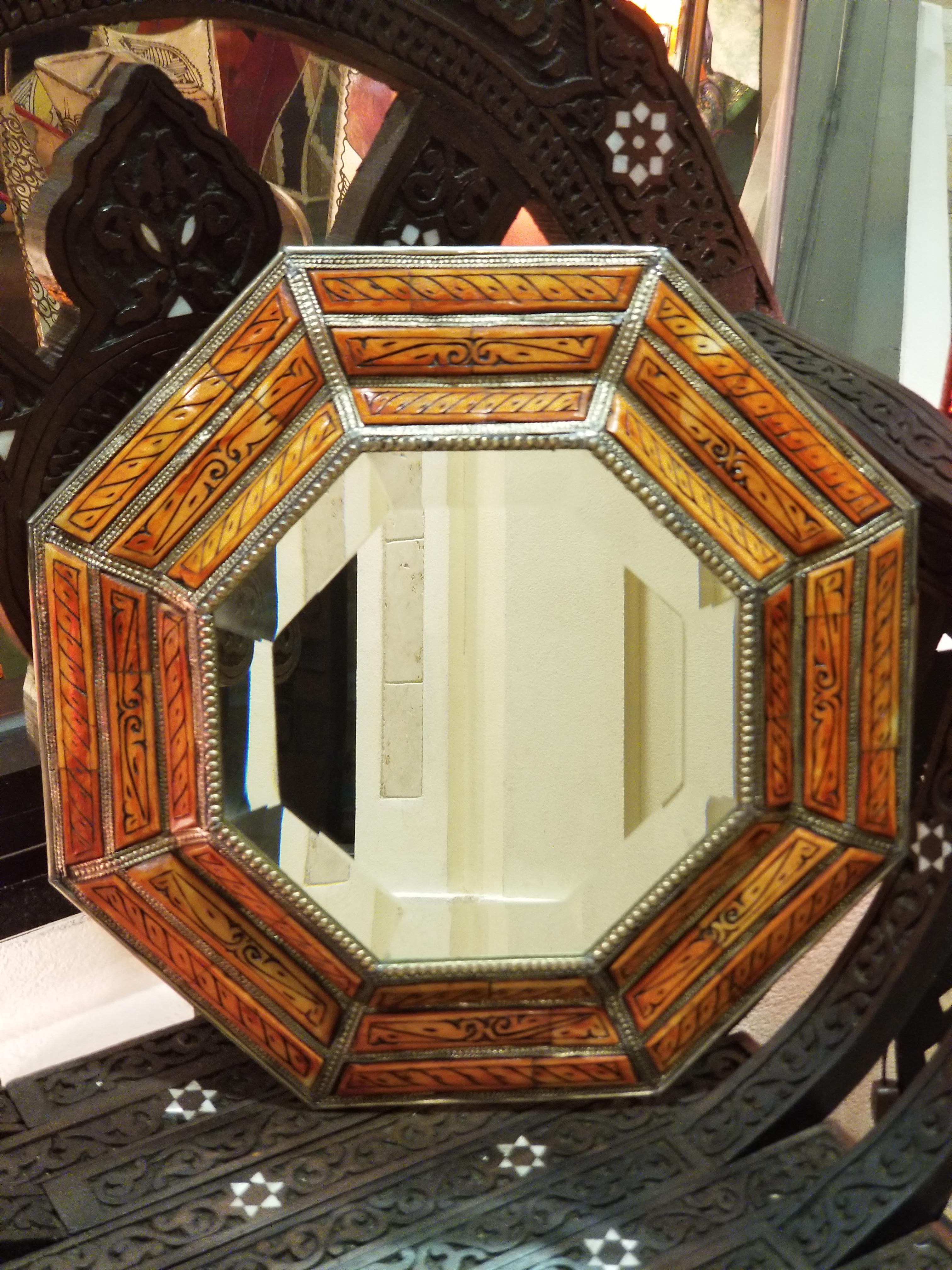 Medium size metal inlaid and camel bone Moroccan mirror. Made in the city of Marrakech. Hexagonal shape measuring approximately 15