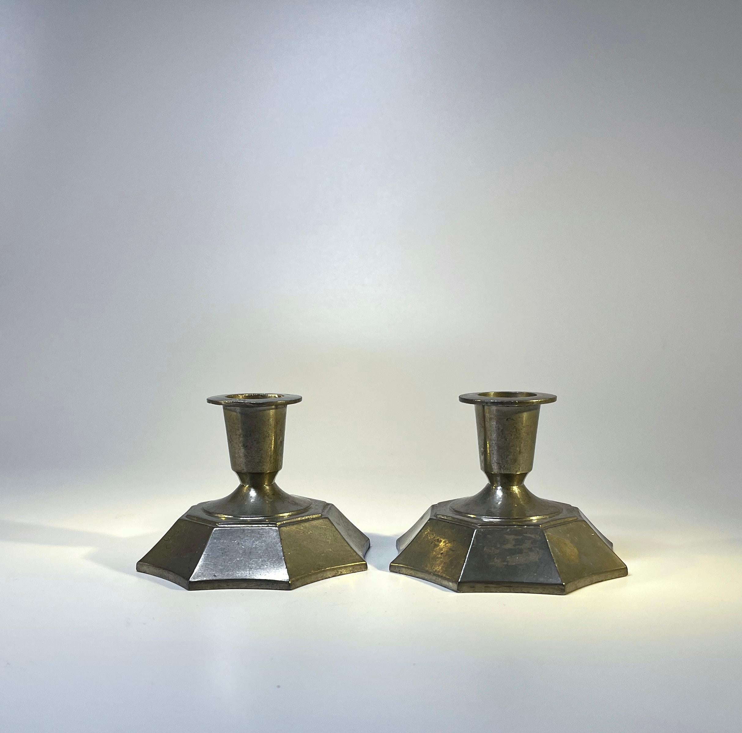 Hexagonal pair of Just Andersen pewter candlesticks. Circa 1930's
Stamped and numbered 1017 on bases
Height 2.5 inch, Diameter 3.25 inch, 
In good, sound condition 