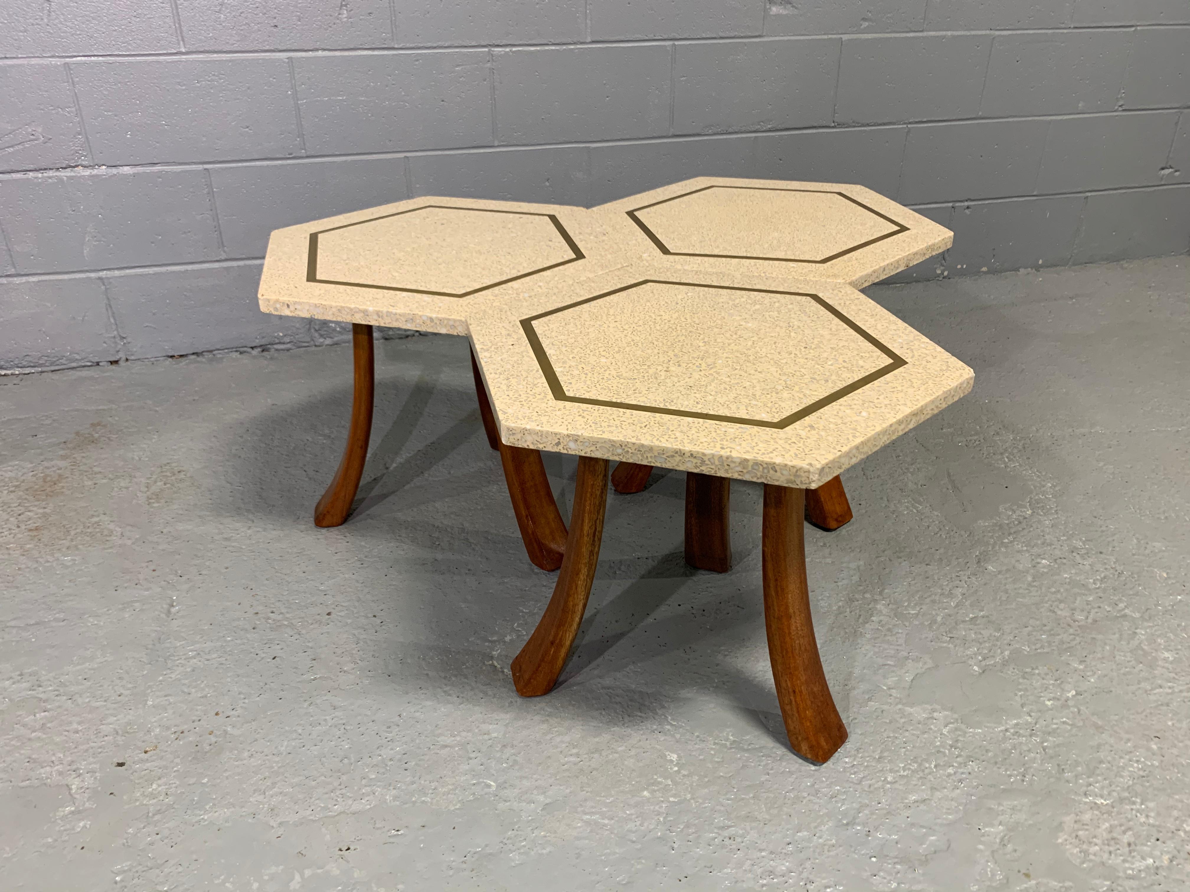 Mid-Century Modern Harvey Probber designed three-legged hexagonal side table. The terrazzo stone top has brass inlay and is supported by mahogany legs.