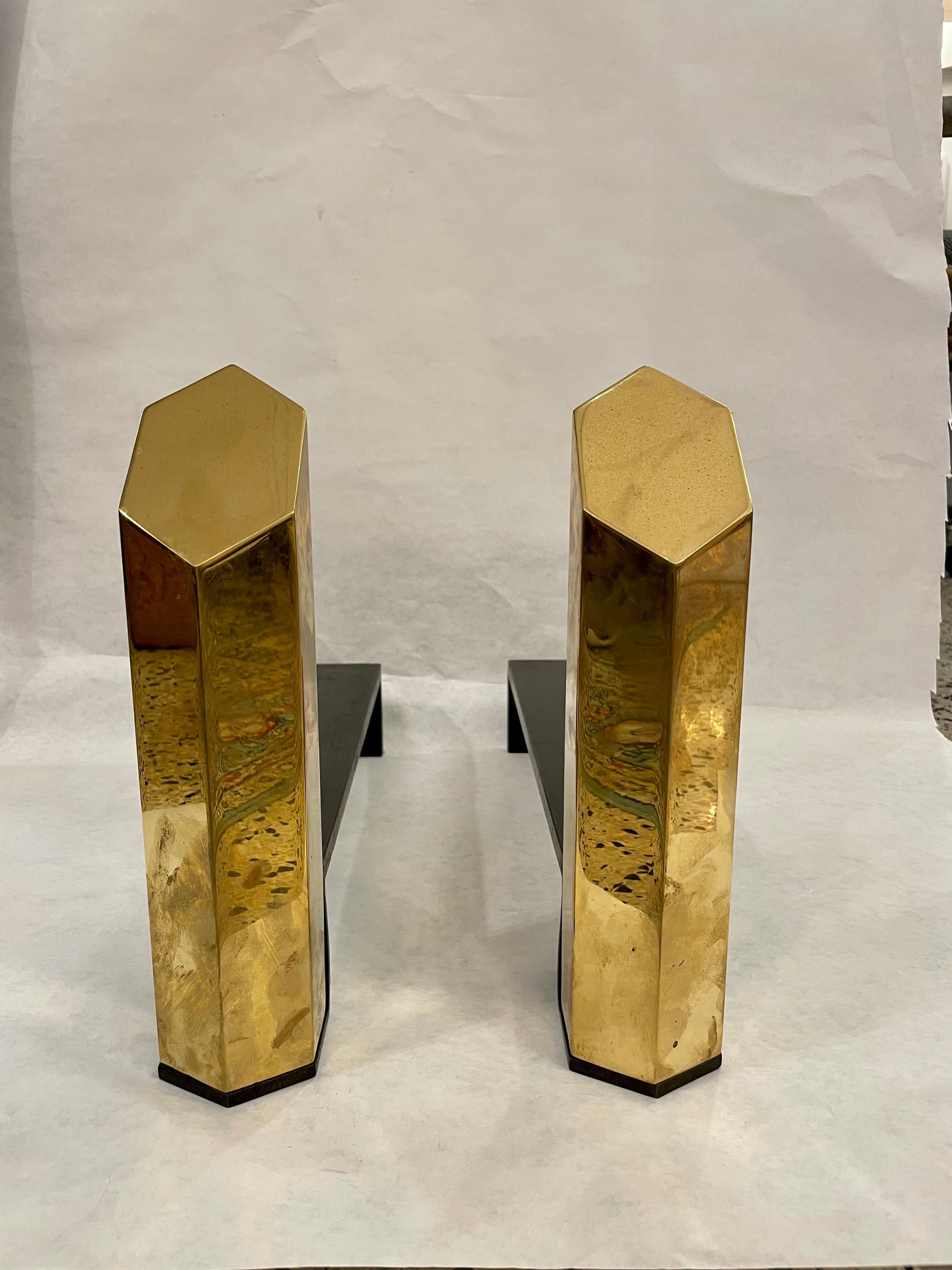 Breathtaking - sculptural yet simple, these are heavy architectural design solid brass andirons are hexagonal cut on angle to augment the beauty of the brass and play on geometrical shapes.

Hexagonal brass column is 2.5
