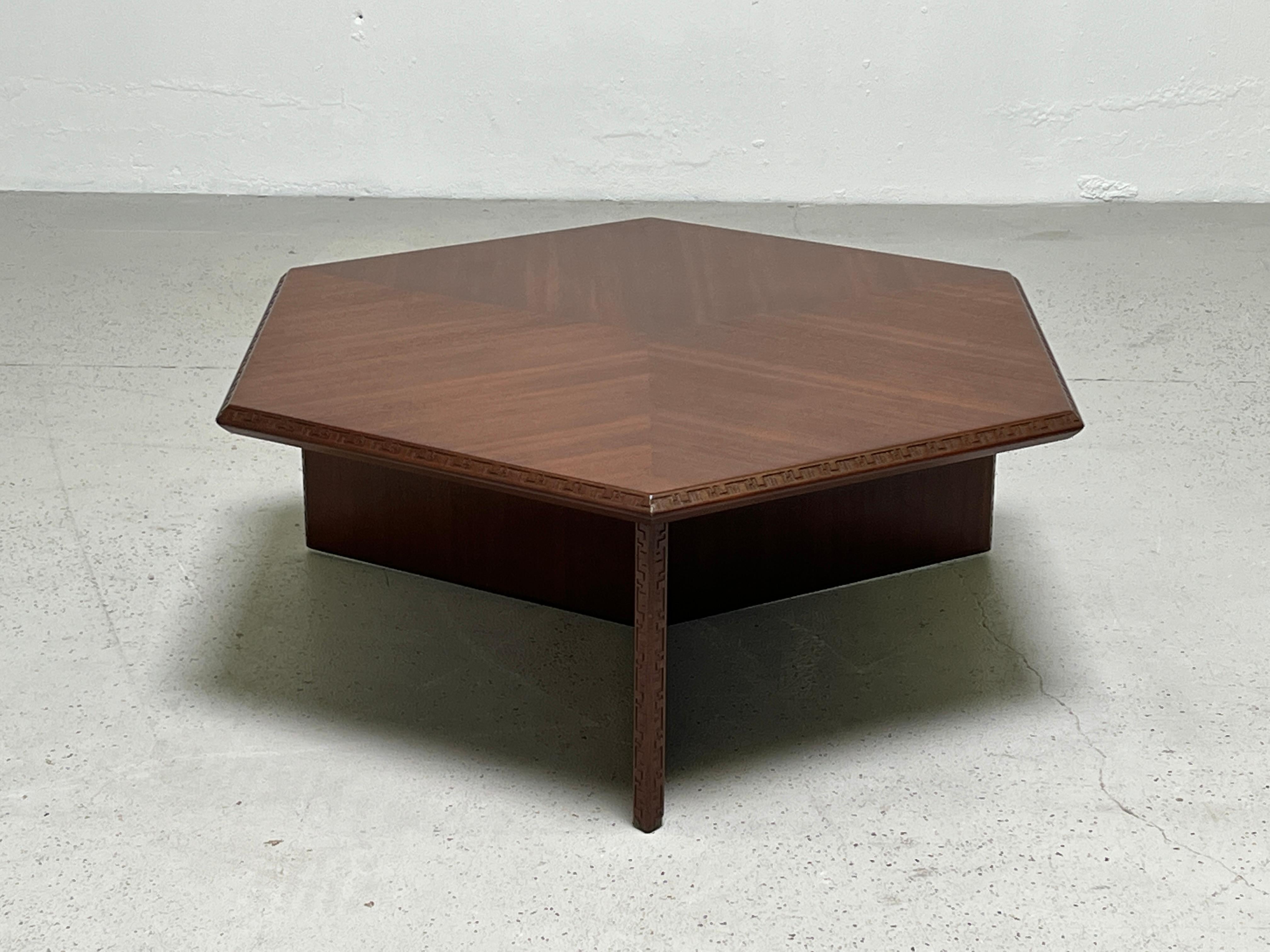 A mahogany hexagonal coffee table designed by Frank Lloyd Wright for Henredon.