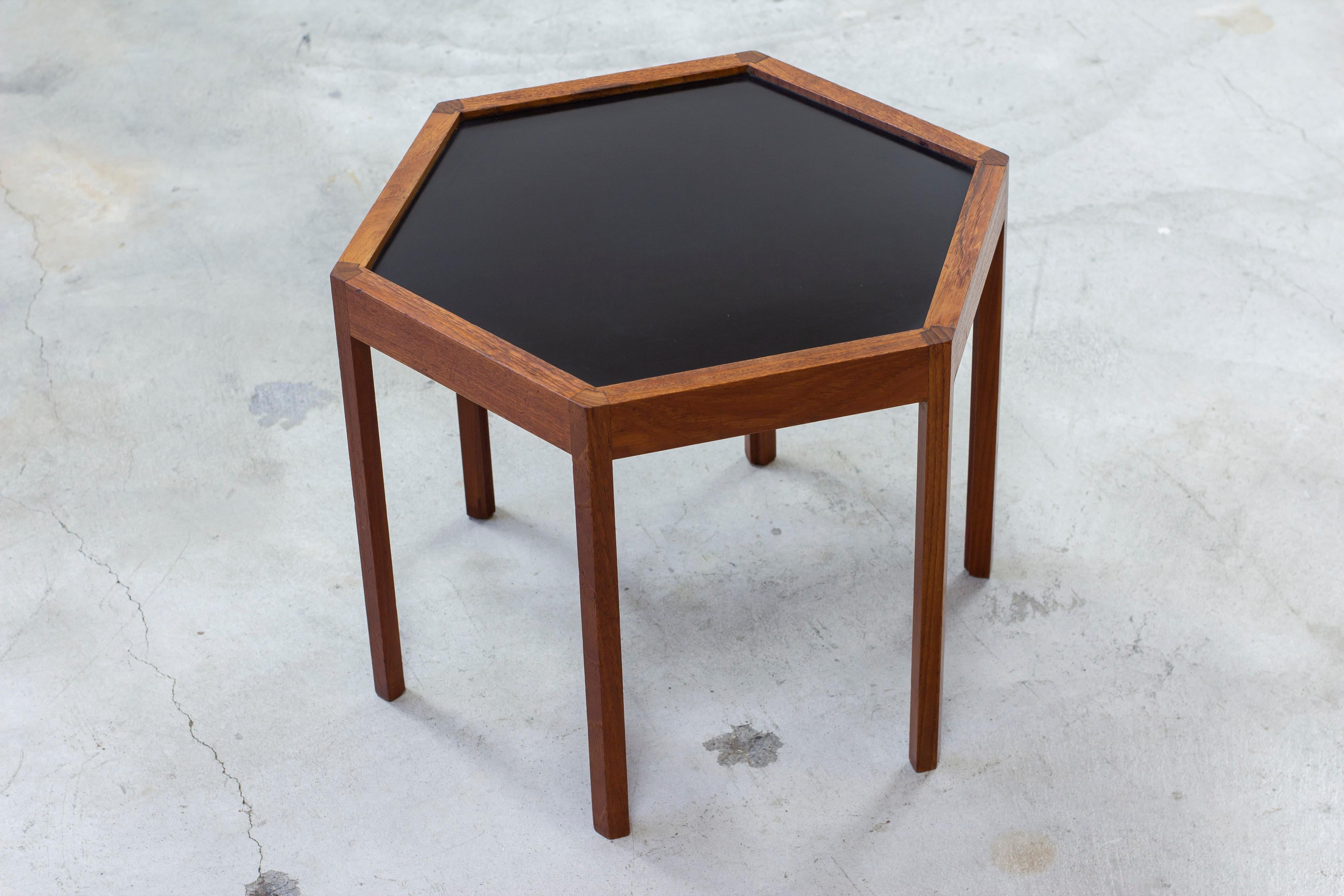 Hexagonal side table designed by Hans C. Andersen. Produced in Denmark during the 1950 by Artex. Teak base with formica table top. Very nice joinery detail between the legs and table frame. Good vintage condition with light age related wear and