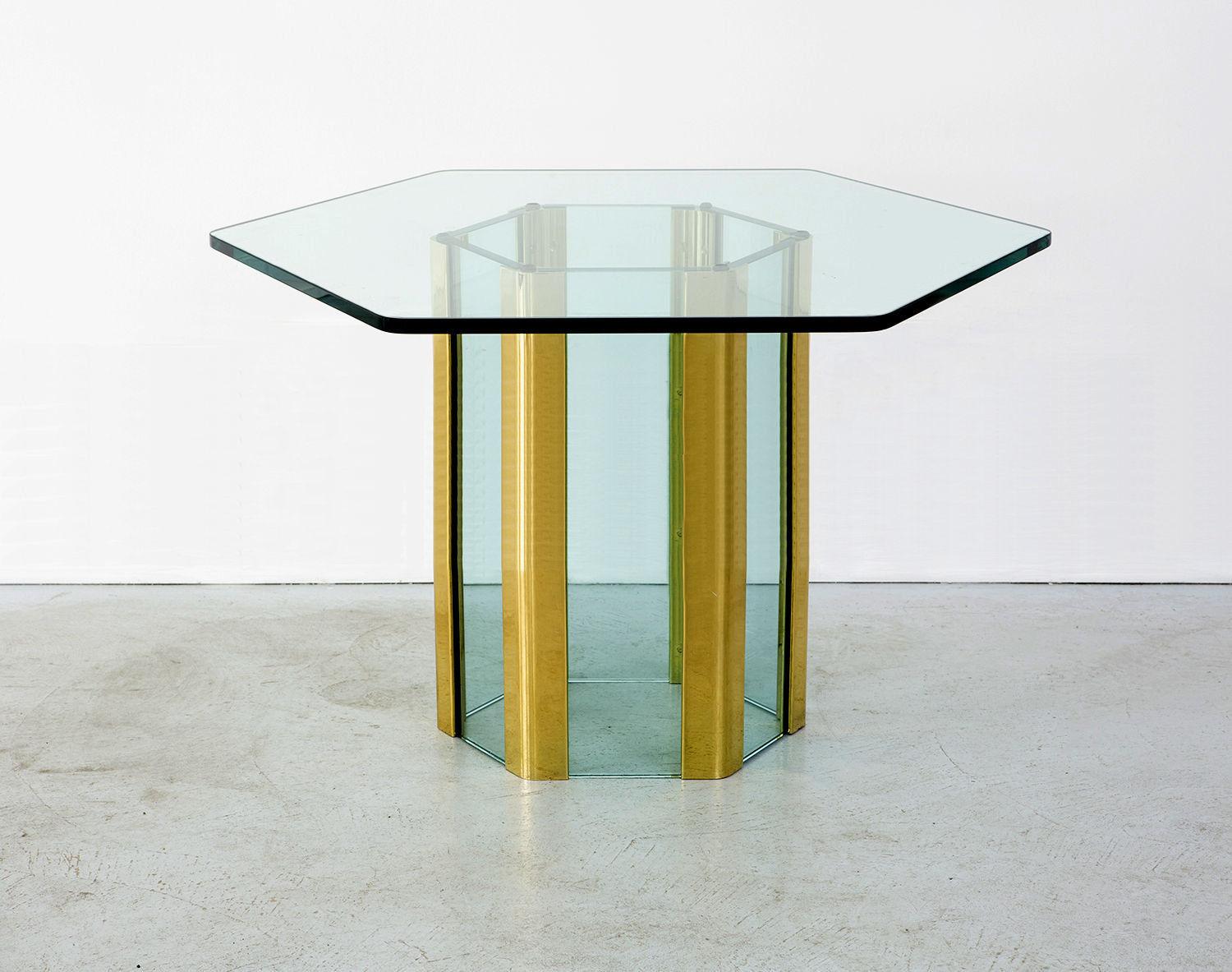An elegant waterfall dining table designed by Leon Rosen for The Pace Collection in a rare hexagonal form. Thick glass with corners of solid nickel dipped in gold, with a nice patina. Stunning.

Dimensions are for the base, measured side to side.