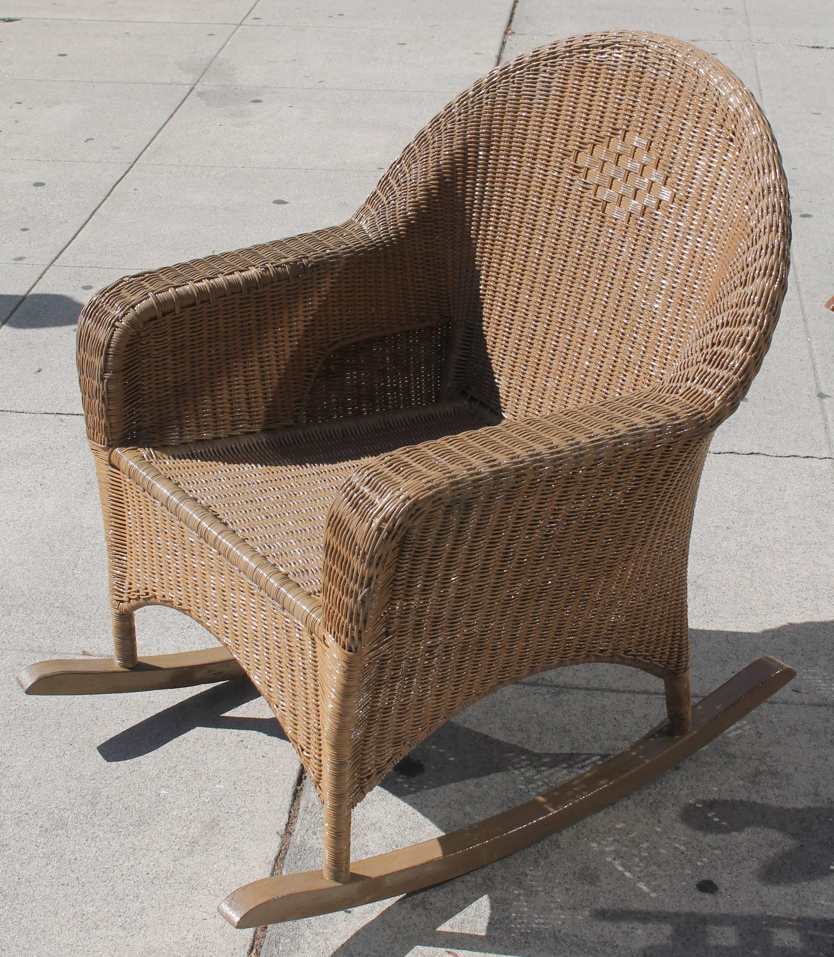 Beautiful light brown painted tan surface. Haywood wake field wicker rocker in strong and sturdy condition with a light varnish finish for outdoor all weather protection.