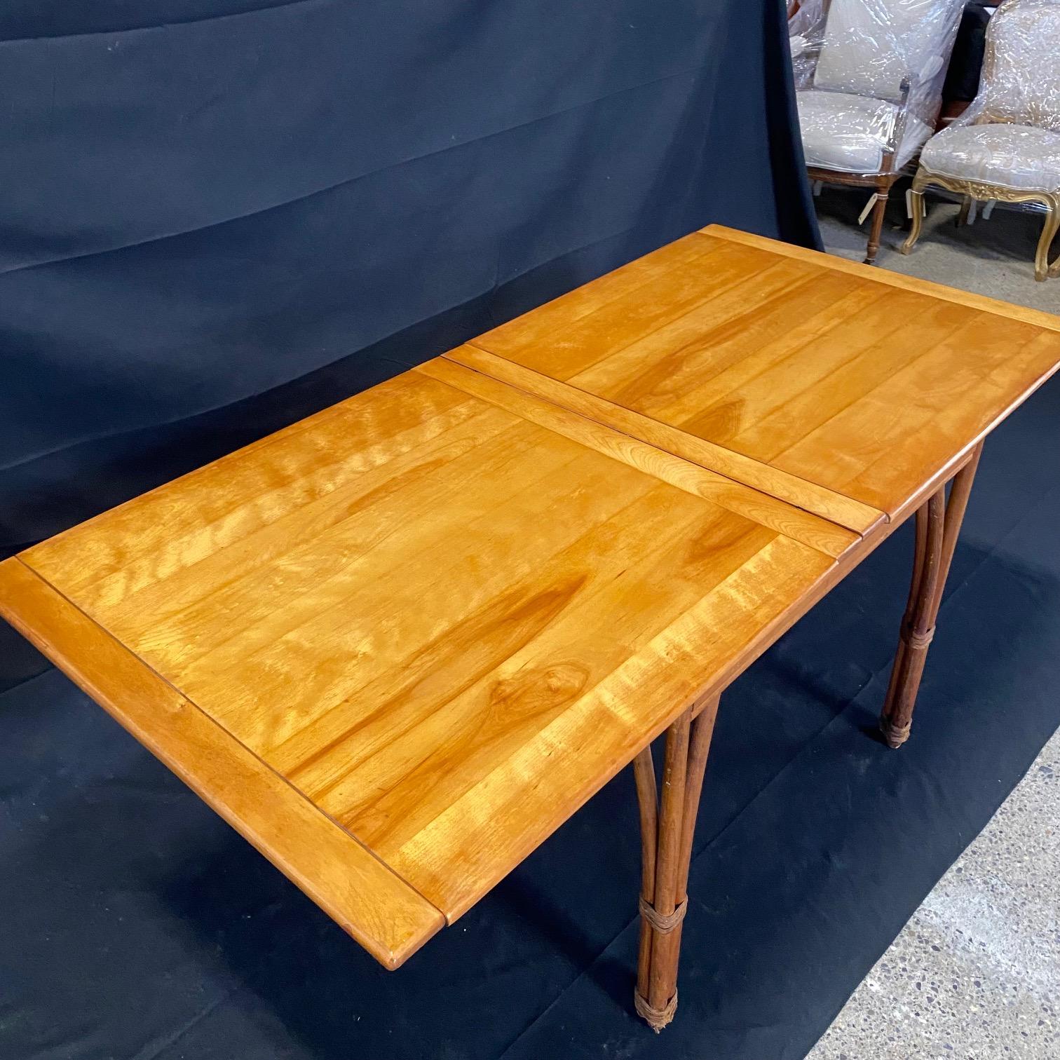 Rattan and maple super stylish and versatile Heywood Wakefield Hollywood Regency style faux bamboo dining table that expands to double its size. From the fabulous 1940s. Table when open and extended:
H 28”
D 32.5”
W 64.5”
Table when closed