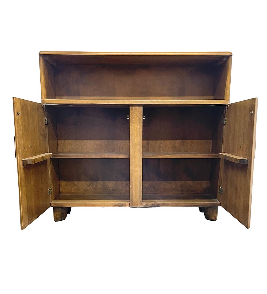 Wonderful smaller Heywood Wakefield cabinet - originally marked as a bookshelf but can be used as a bar or a sideboard in many ways. The finish is original and is called Sable. Wonderful rectangle hardware reminiscent of the era n which it was