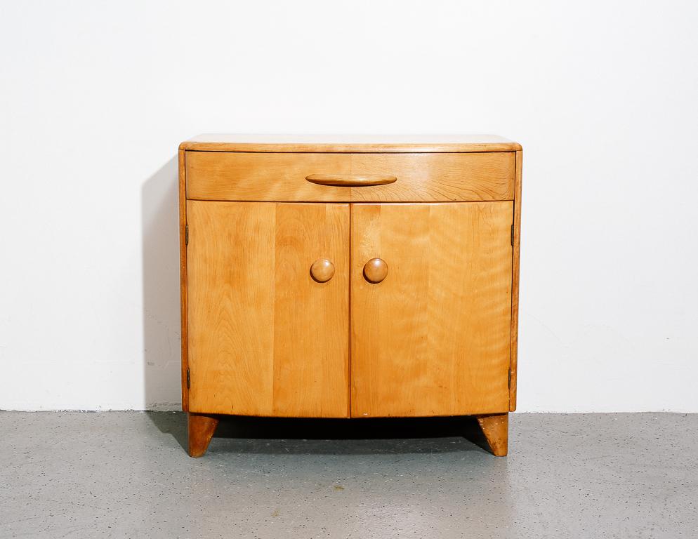 Heywood Wakefield cabinet or nightstand from the 'Crescendo' series. Deco-inspired stylings with bowed front.