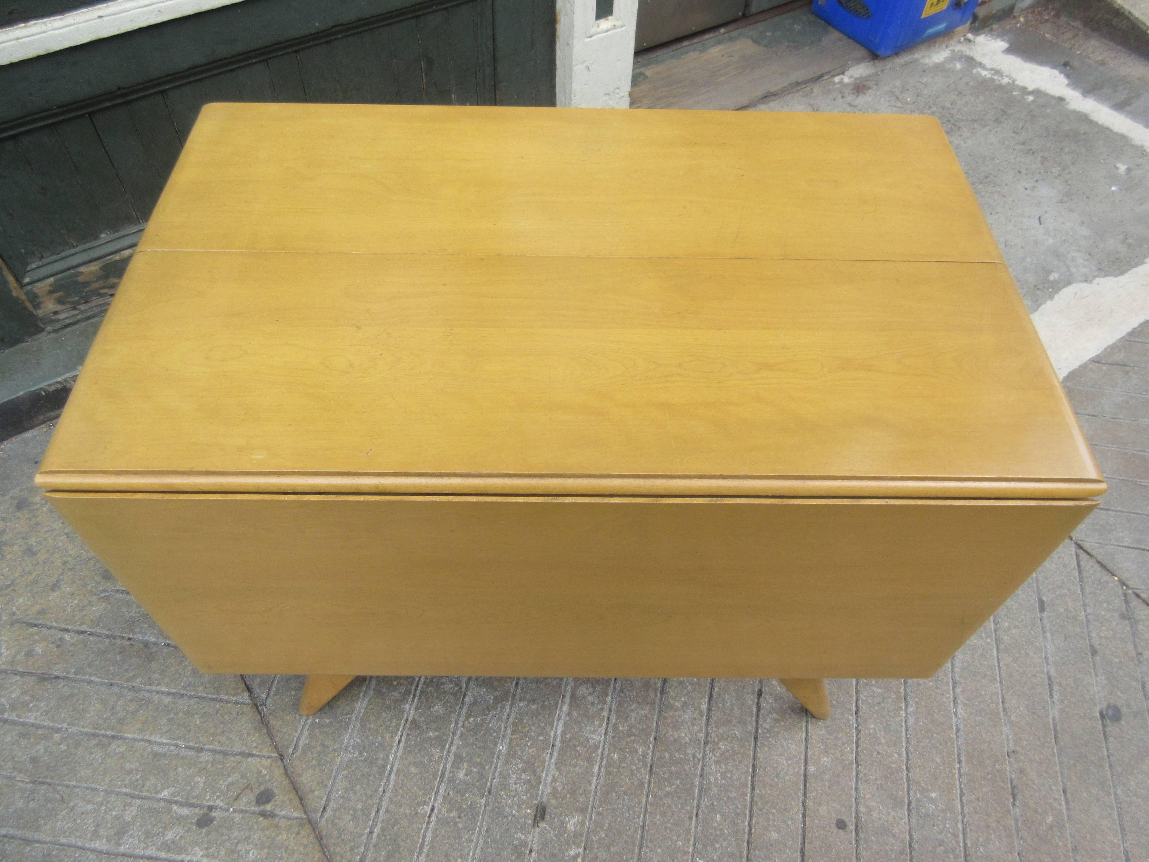 Heywood Wakefield drop-leaf table with two leaves. Very useful and sturdy table even fully extended! Table is all original, and does show some surface wear, late 1950s or early 1960s design. Table can be used in a multiple of configurations with one