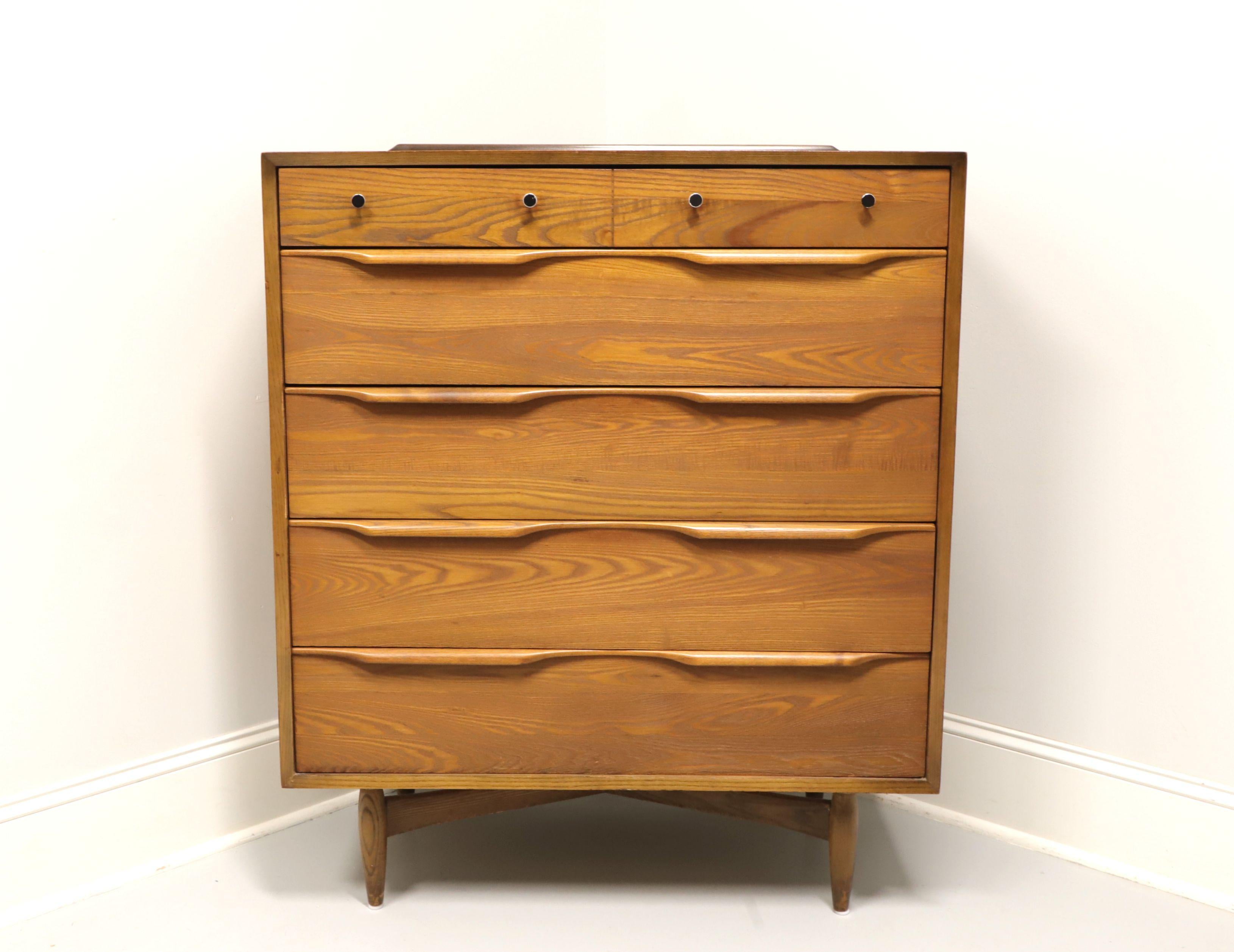 A Mid-20th Century Modern chest of drawers by Heywood Wakefield. Walnut with metal hardware, wood back gallery to top, 