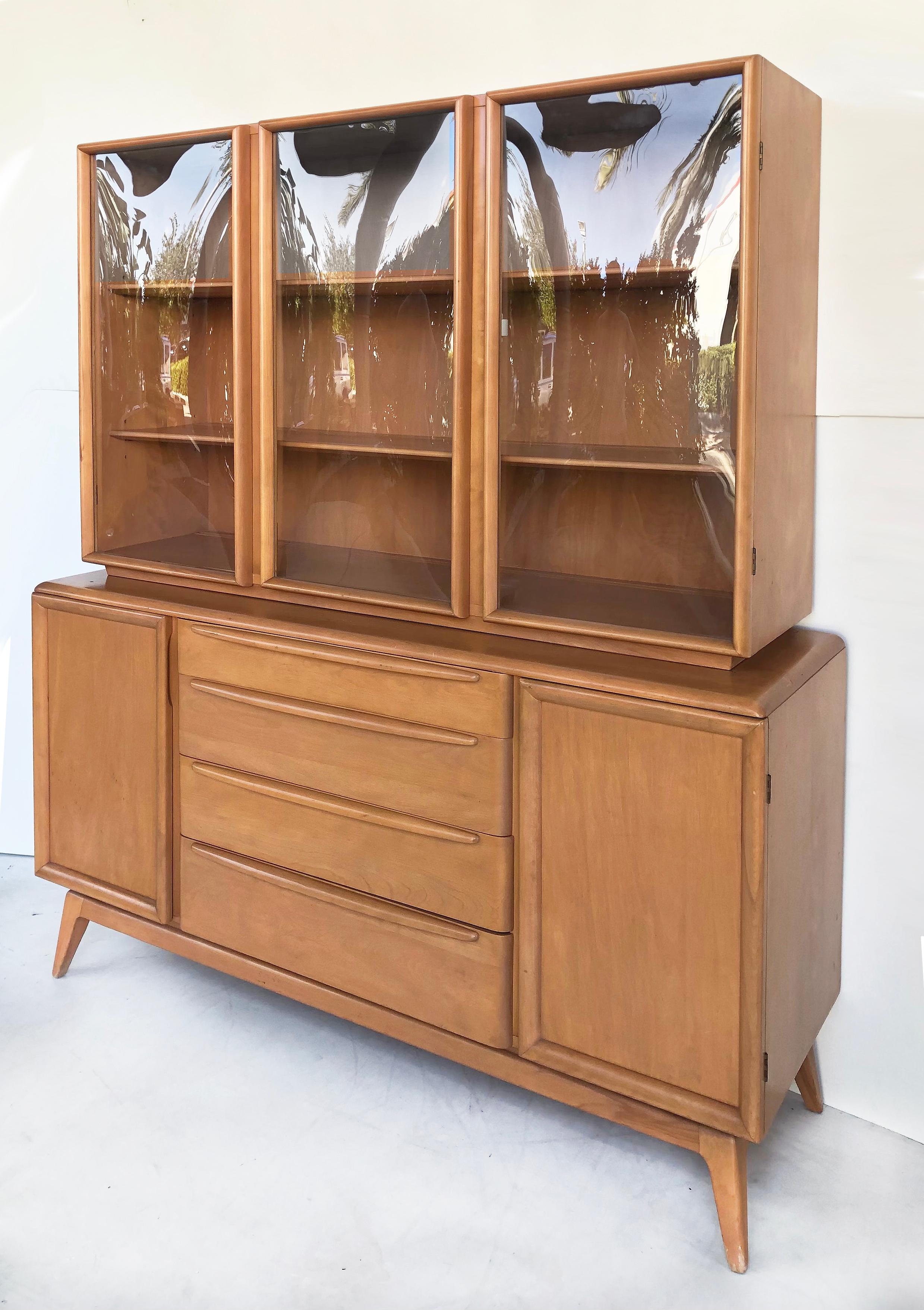 Heywood Wakefield Mid-century Bubble Glass Breakfront China cabinet

Offered for sale is a mid-century modern Heywood Wakefield two-part china cabinet on stand with bubble glass doors. The top cabinet has three bubbled glass doors that open to