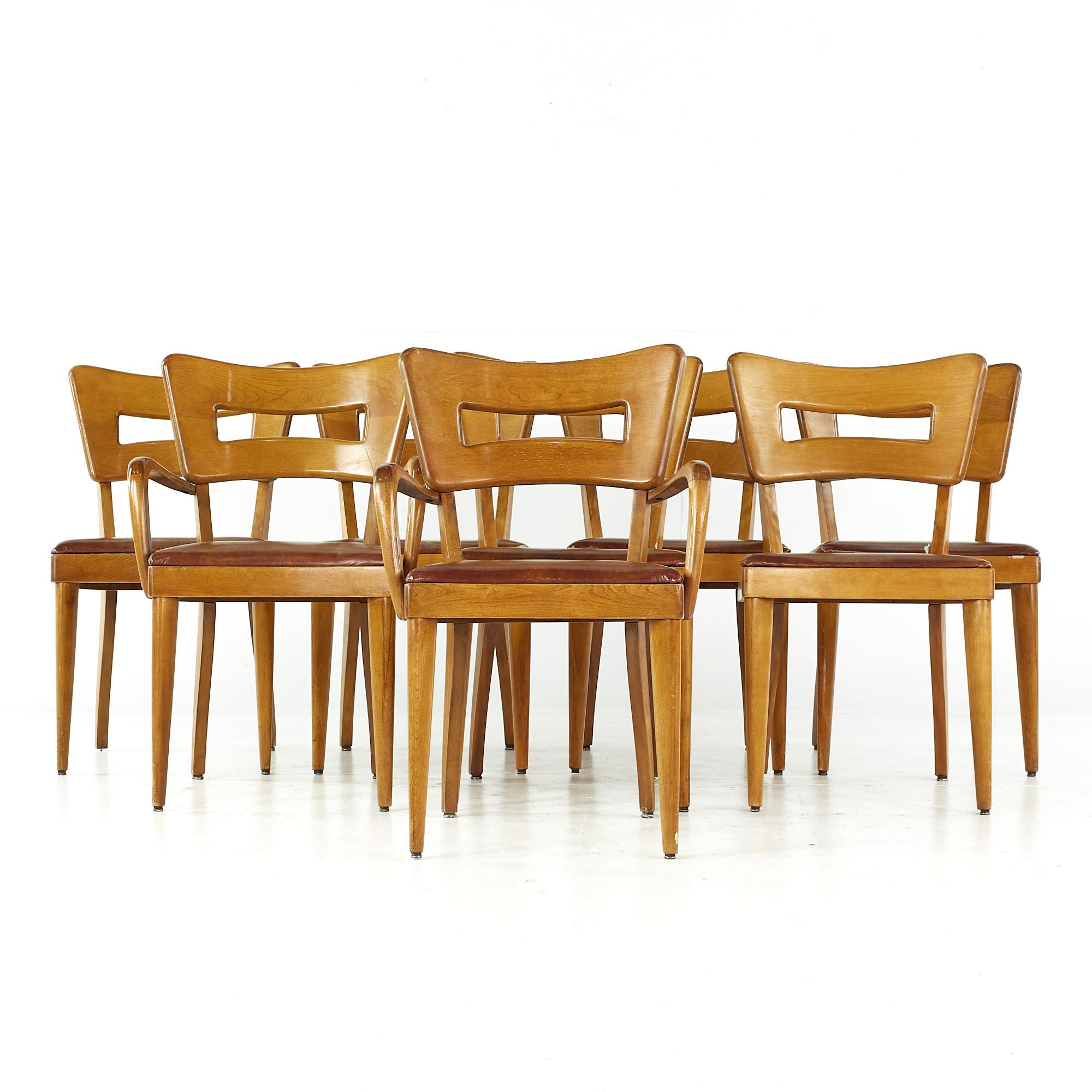 Heywood Wakefield midcentury dogbone chairs - set of 8.

Each armless chair measures: 17.75 wide x 17 deep x 33 high, with a seat height of 18.5 inches.
Each captains chair measures: 22 wide x 17 deep x 33 high, with a seat height of 18.5 inches,