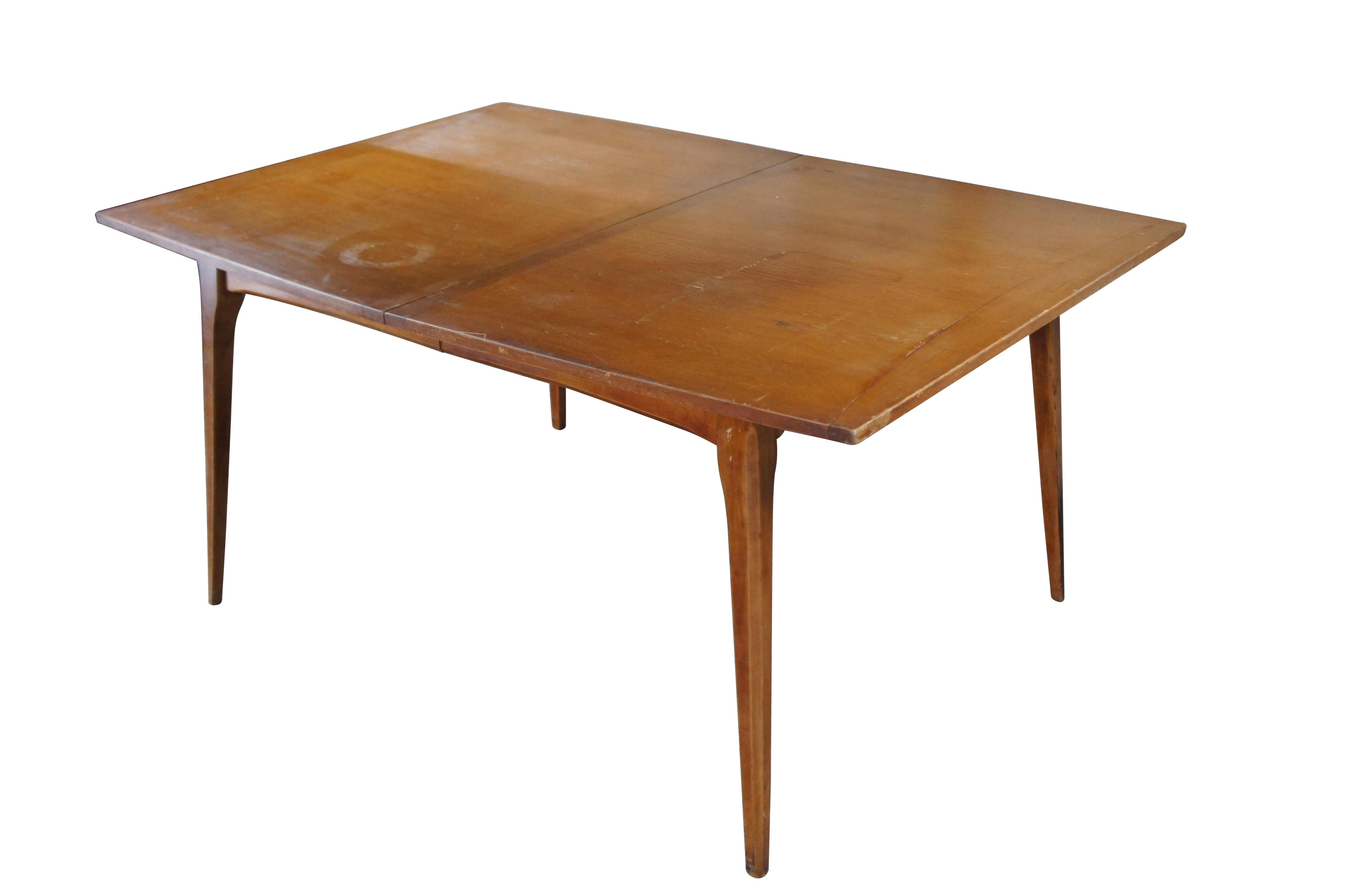 Heywood Wakefield American Maple Dining Table.  Features a rectangular form with tapered sides and square tapered legs.  Includes two leaves for extension.

Dimensions:
60.5