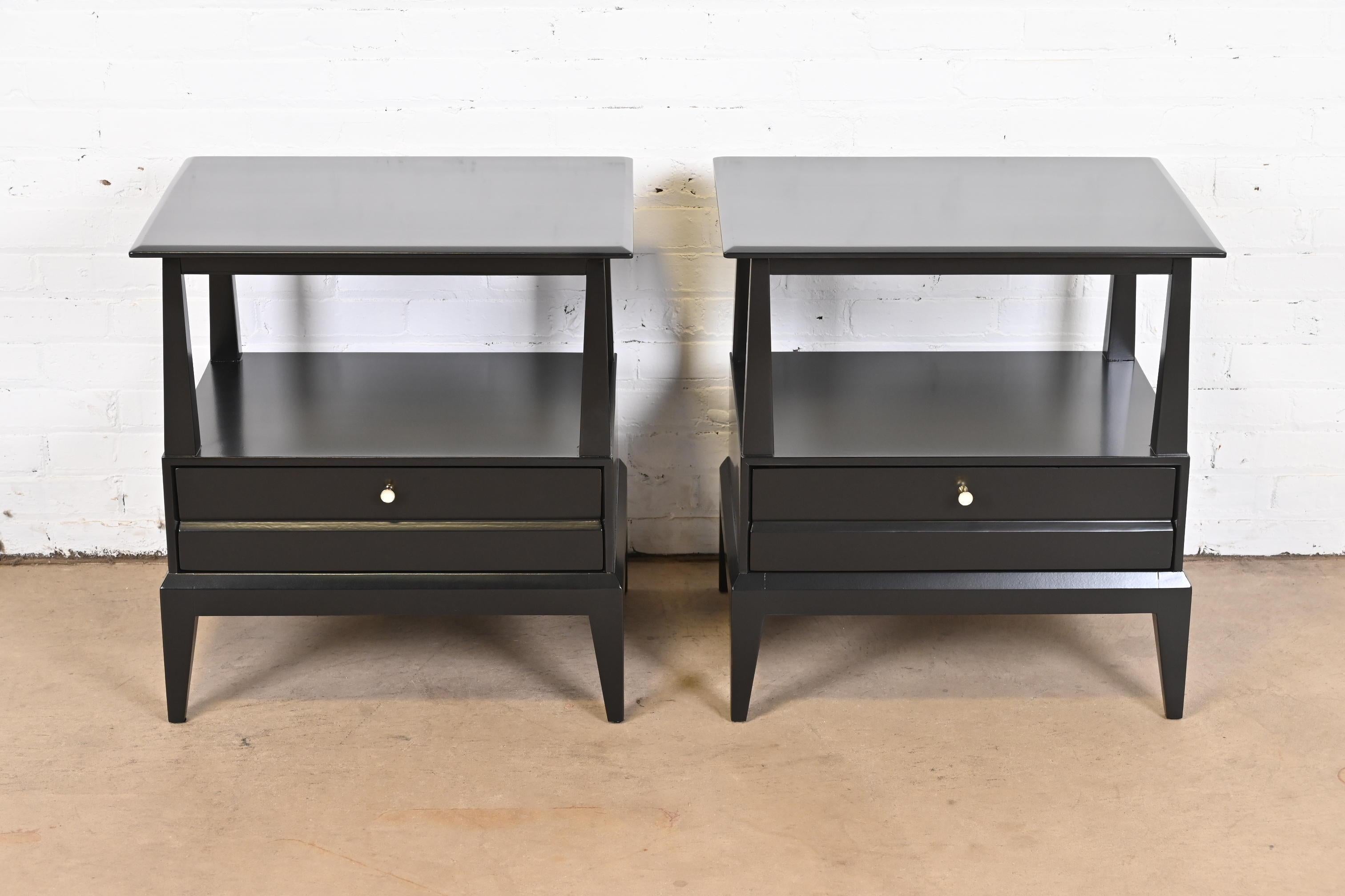 A gorgeous pair of Mid-Century Modern nightstands or end tables

By Heywood Wakefield

USA, 1950s

Black lacquered maple, with brass hardware.

Measures: 24