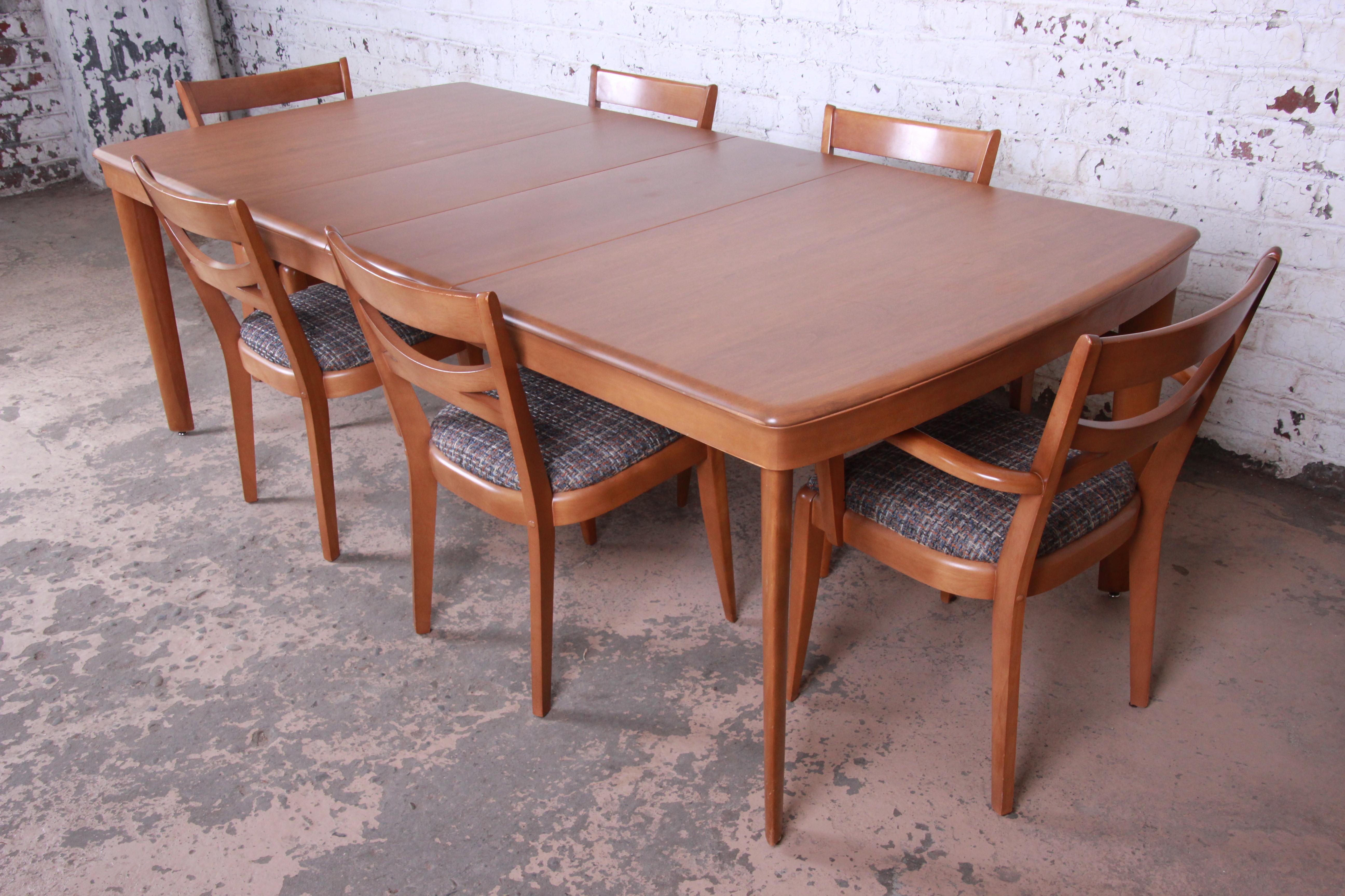 Offering a very nice Heywood Wakefield Mid-Century Modern extension dining table and 6 chairs. The set includes the dining table, two leaves, and six dining chairs. The table extends to 90.5