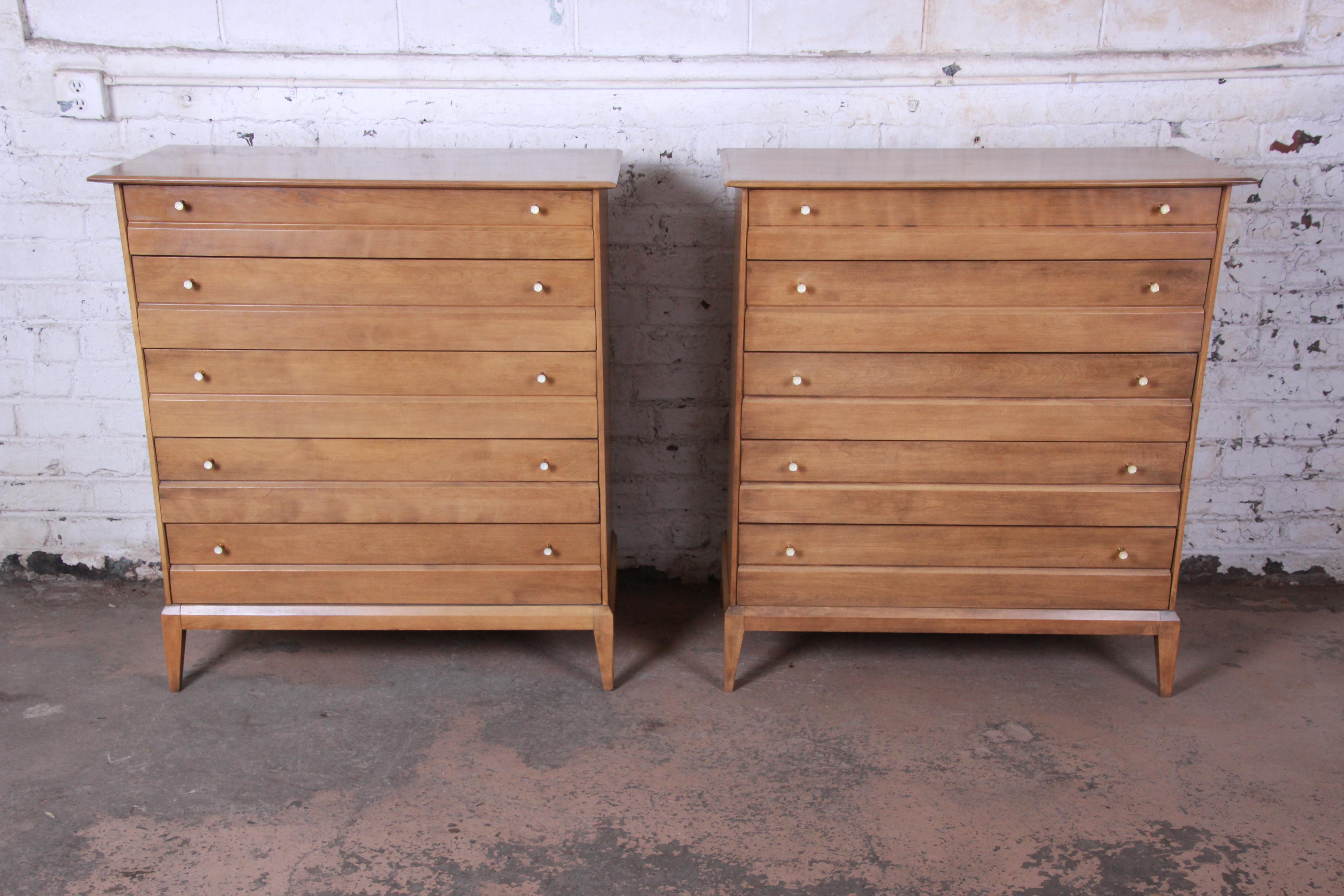 Offering a very nice pair of Mid-Century Modern Heywood-Wakefield highboy dressers. Each dresser has five smooth sliding drawers that offers lots of room for storage. The dresser has nice modern tapered legs with midcentury lines. The dressers are