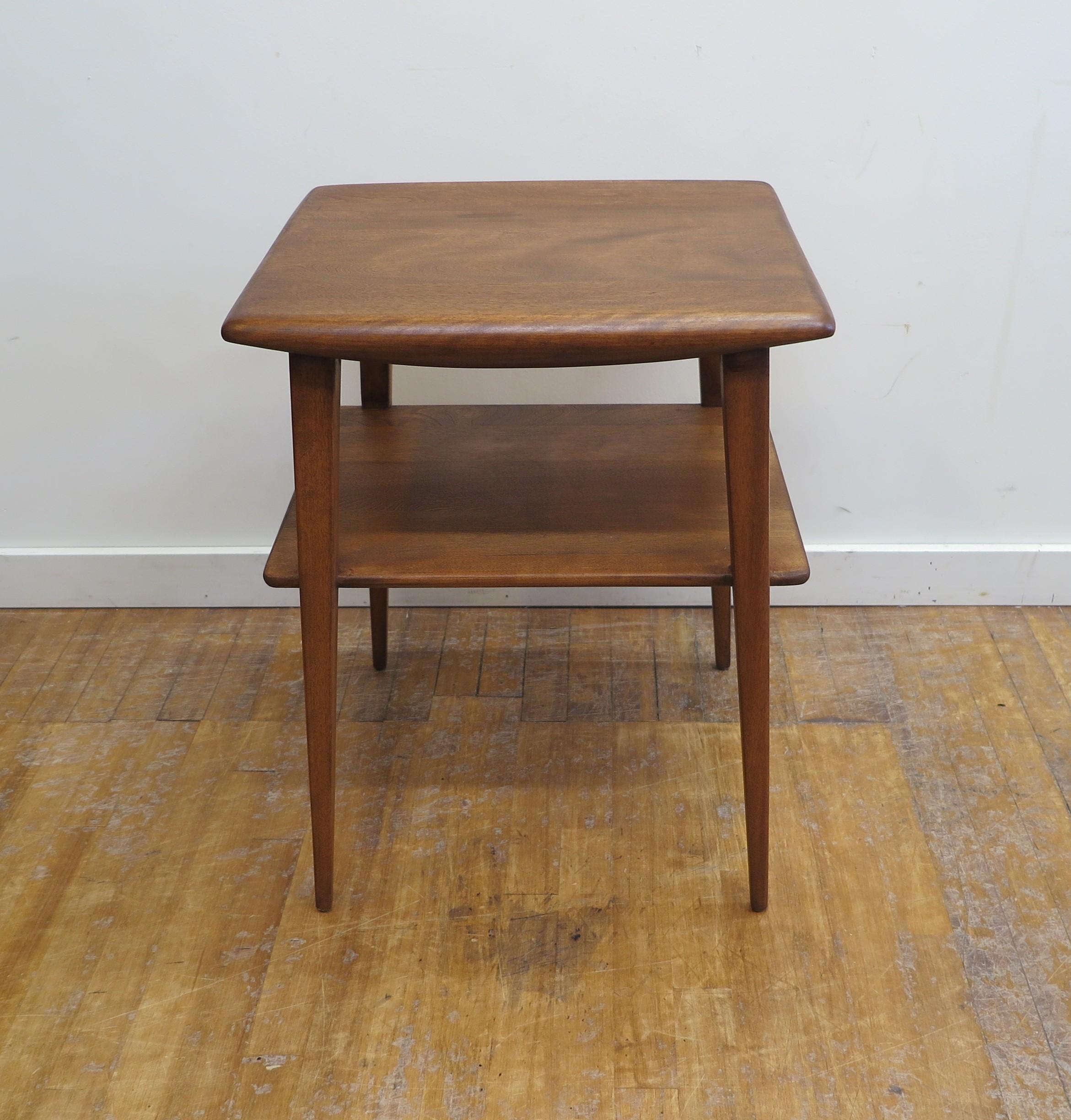 Mid-Century Modern Heywood Wakefield side table. Sculpted top with rounded edges having two shelves supported on tapered splayed legs. Timeless design solid maple in very good condition. Heywood Wakefield Trademark to underside. American Mid Century