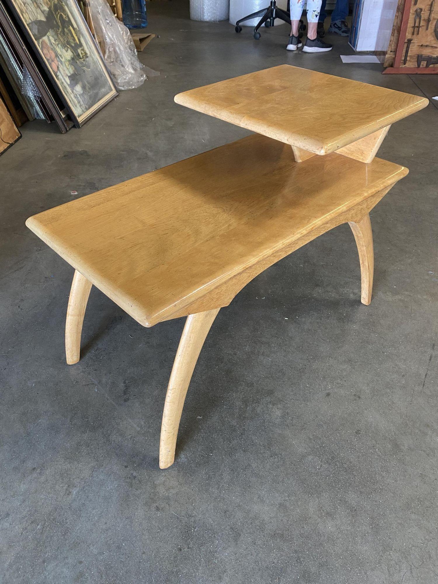 Original Mid-century Heywood Wakefield step two-tier side tables featuring arched legs with a wheat finish.
Branded 