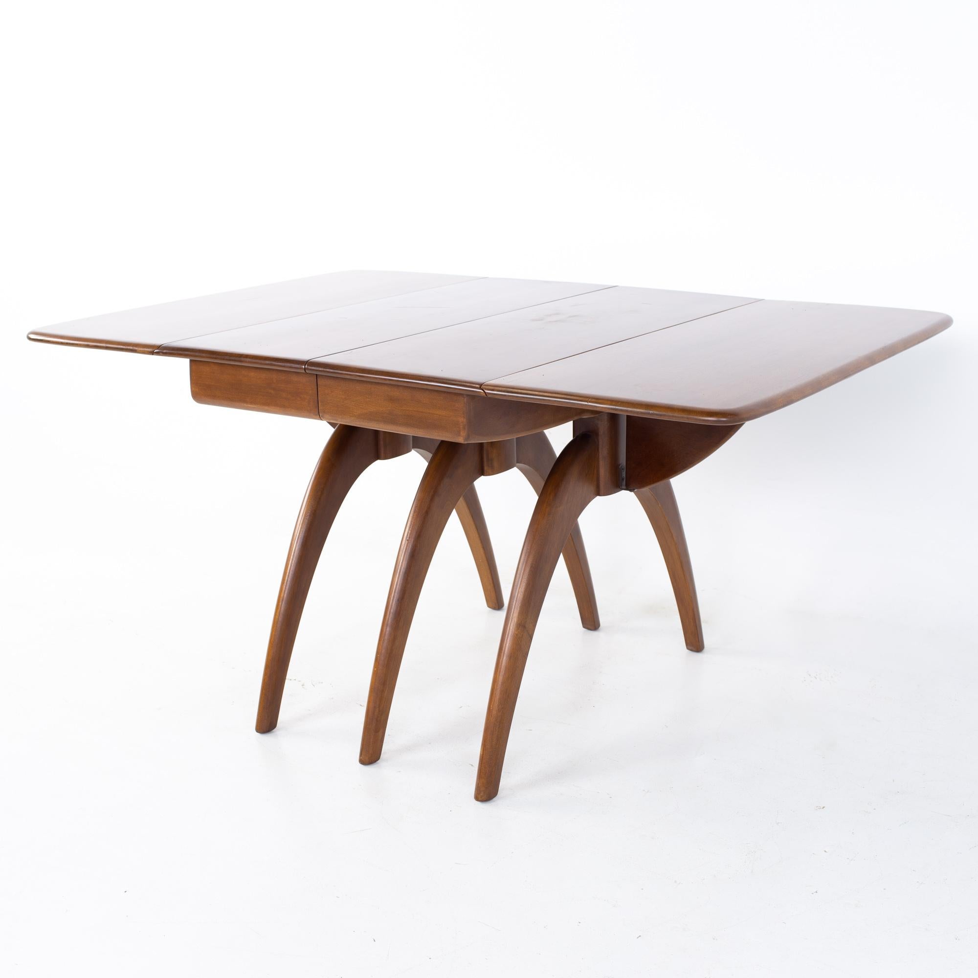 Heywood Wakefield mid century wishbone dining table.
Table measures: 58 wide x 40 deep x 29 inches high; each leaf is 18.25 inches wide, making a maximum table width of 94.5 inches when both leaves are used 

All pieces of furniture can be had in