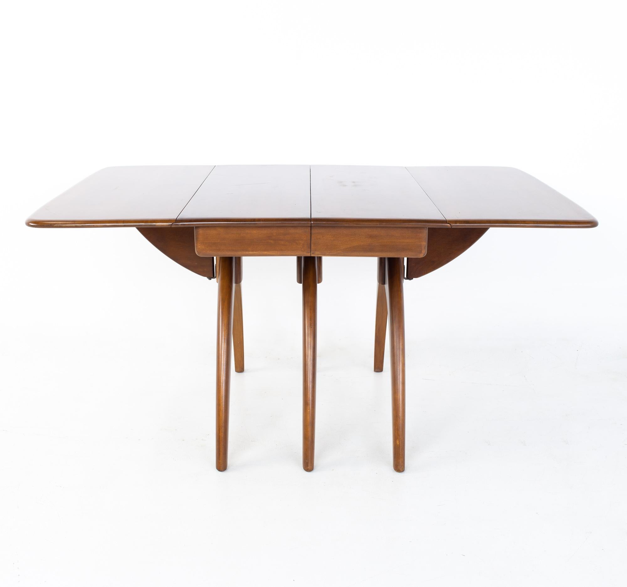 Heywood Wakefield mid-century wishbone dining table.

Table measures: 58 wide x 40 deep x 29 inches high; each leaf is 18.25 inches wide, making a maximum table width of 94.5 inches when both leaves are used.

All pieces of furniture can be had
