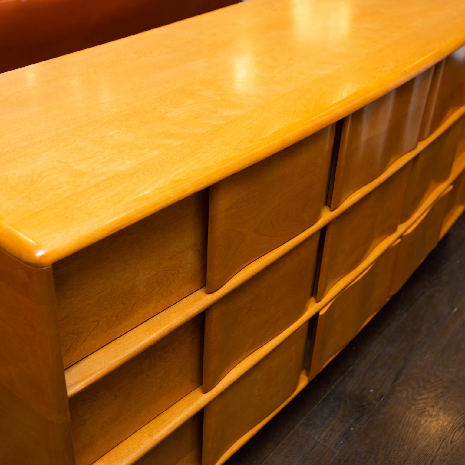 Refinished in a clear coat, this is one of the cooler designs from Heywood Wakefield. Dresser is on original hidden wheels.