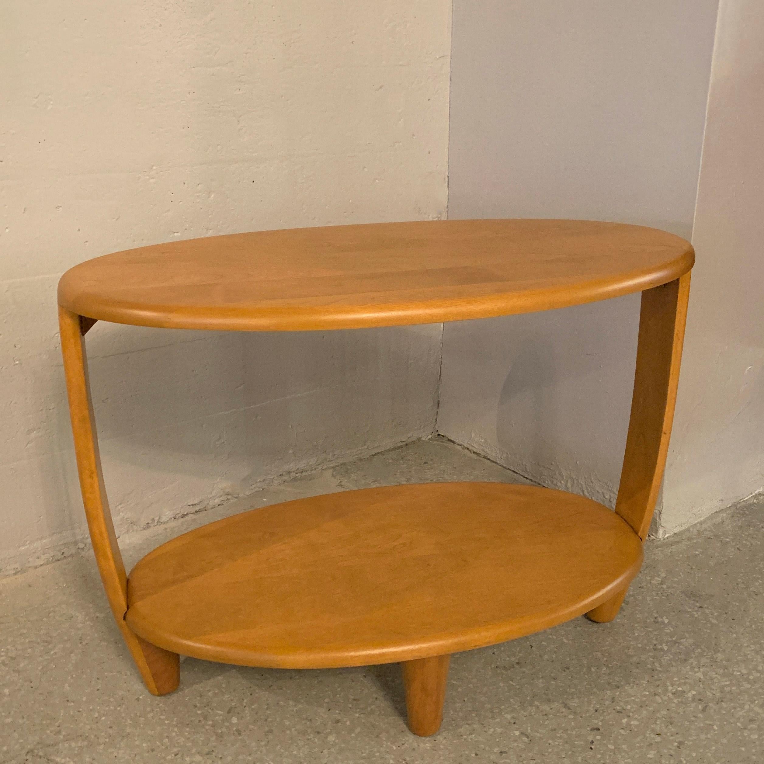 Classic, Mid-Century Modern, oval, tiered birch side table by Heywood Wakefield Co. features a lower tier at 12 inches height.