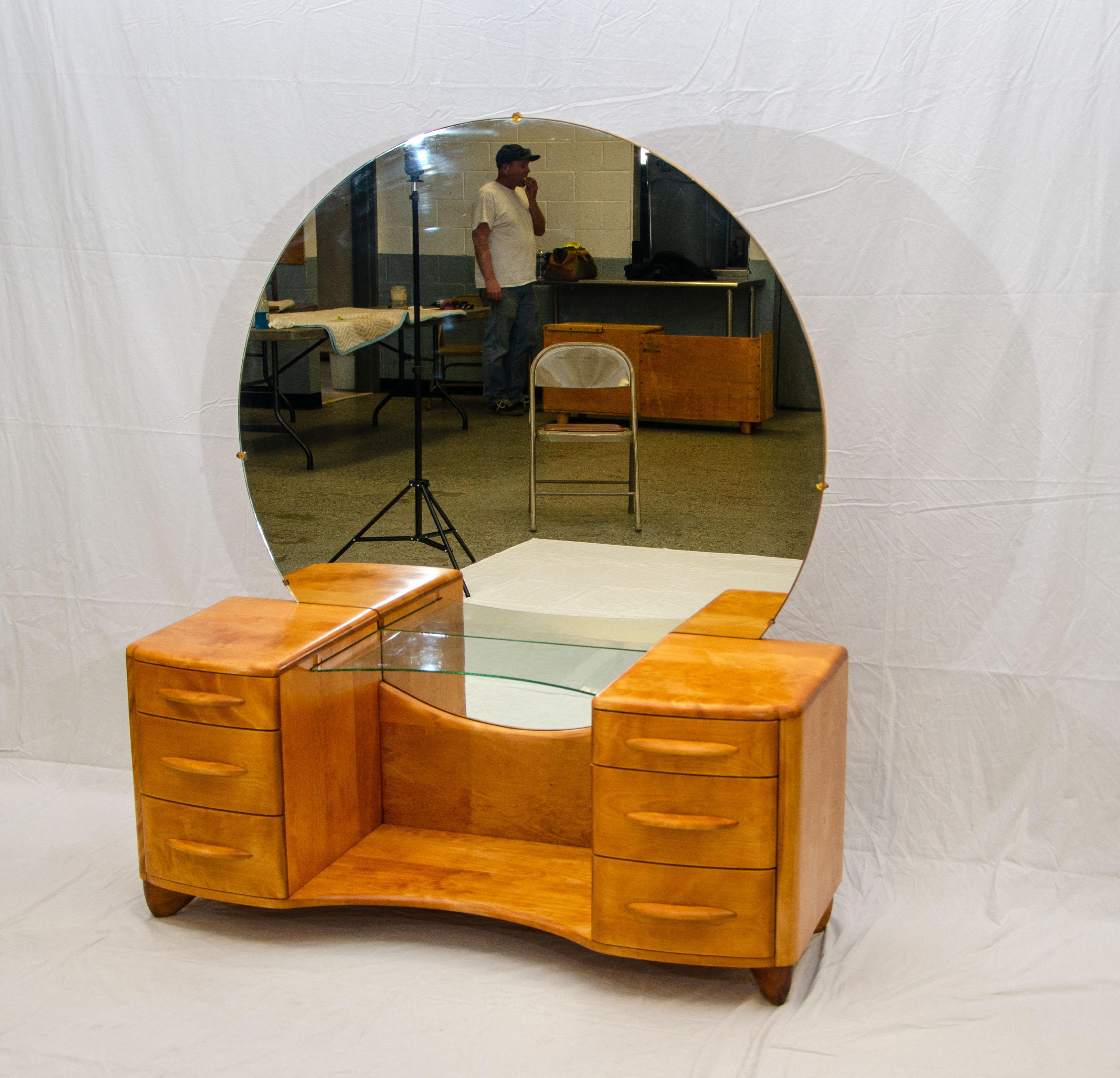 The plaza vanity was manufactured in 1940, it has a curved front glass shelf and a beautiful round mirror that has a 48