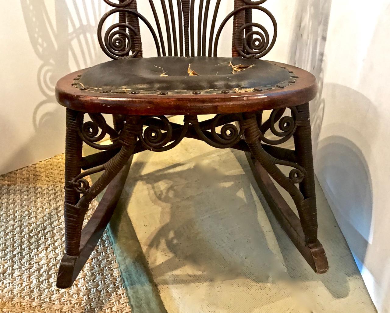 This charming rocking chair is attributed to Heywood Wakefield and dates to the late 19th-early 20th century. The chairs retains all of its original elements and would benefit from a new seat cover. We will reupholster with the customer's fabric.