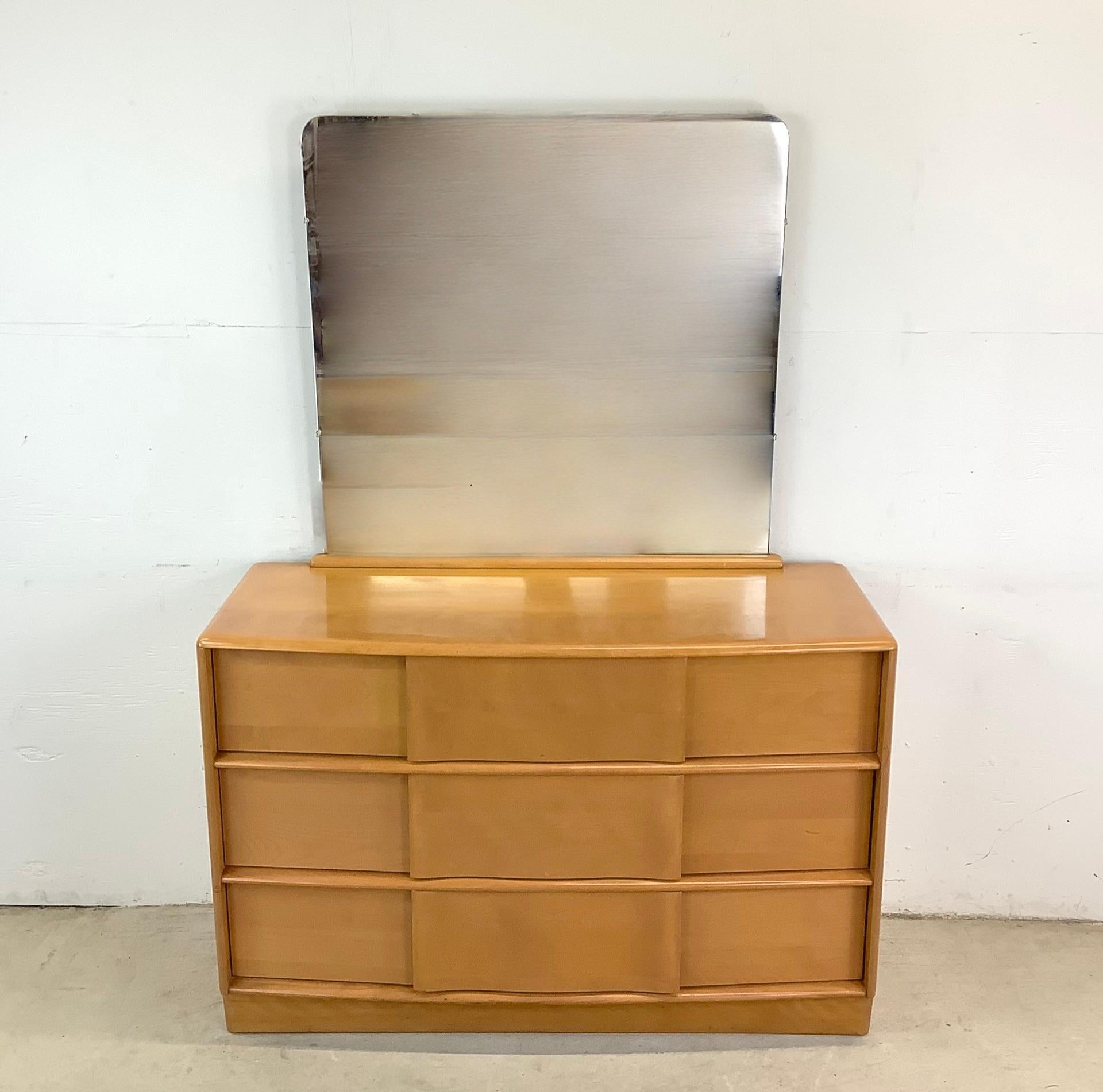 Celebrate the elegance of mid-century modern design with this Heywood Wakefield Sculptura three-drawer chest with mirror, a striking blend of curved detailing, premium craftsmanship, and warm champagne tones. Designed to be both functional and