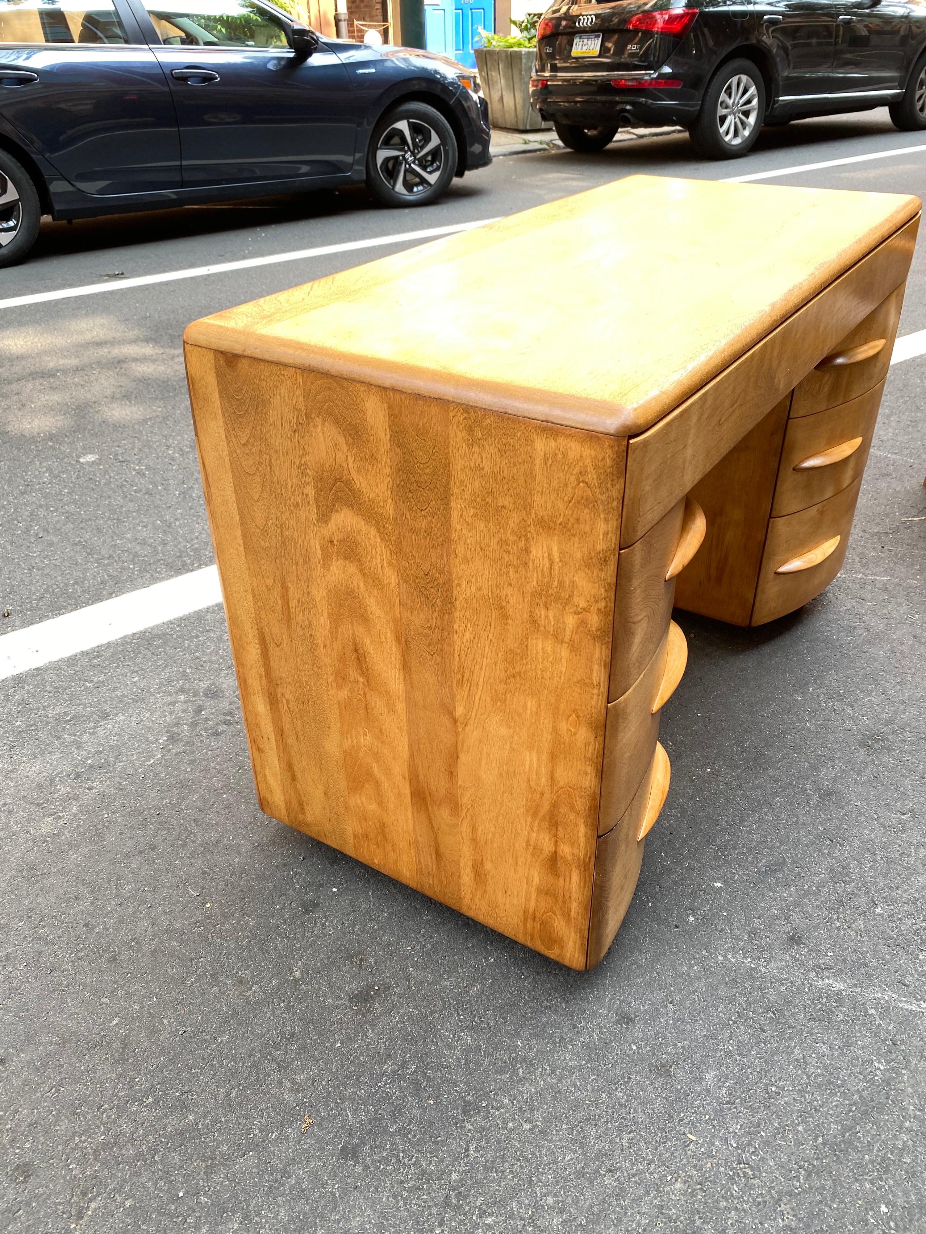 Heywood Wakefield solid maple desk with curved front drawers. Designed by a Count! Highly promoted in the 1950's as one of Heywood Wakefield's Designer, Count Sakhnoffsky. Left side bottom is a file drawer. Just refinished. One of the few American