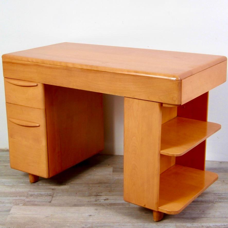 Nice size 1950’s maple student desk by Heywood Wakefield with side book shelves.
    