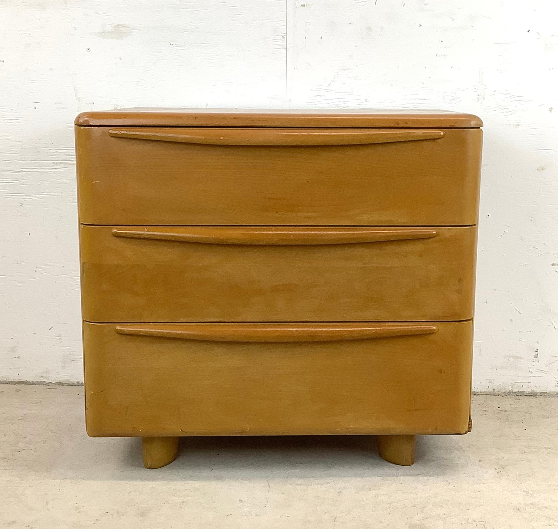 Introducing this mid-century chest of drawers by the renowned Heywood-Wakefield, finished in a luxurious champagne hue. This versatile maple chest, perfect as a bedside nightstand, embodies both style and functionality, making it an ideal addition