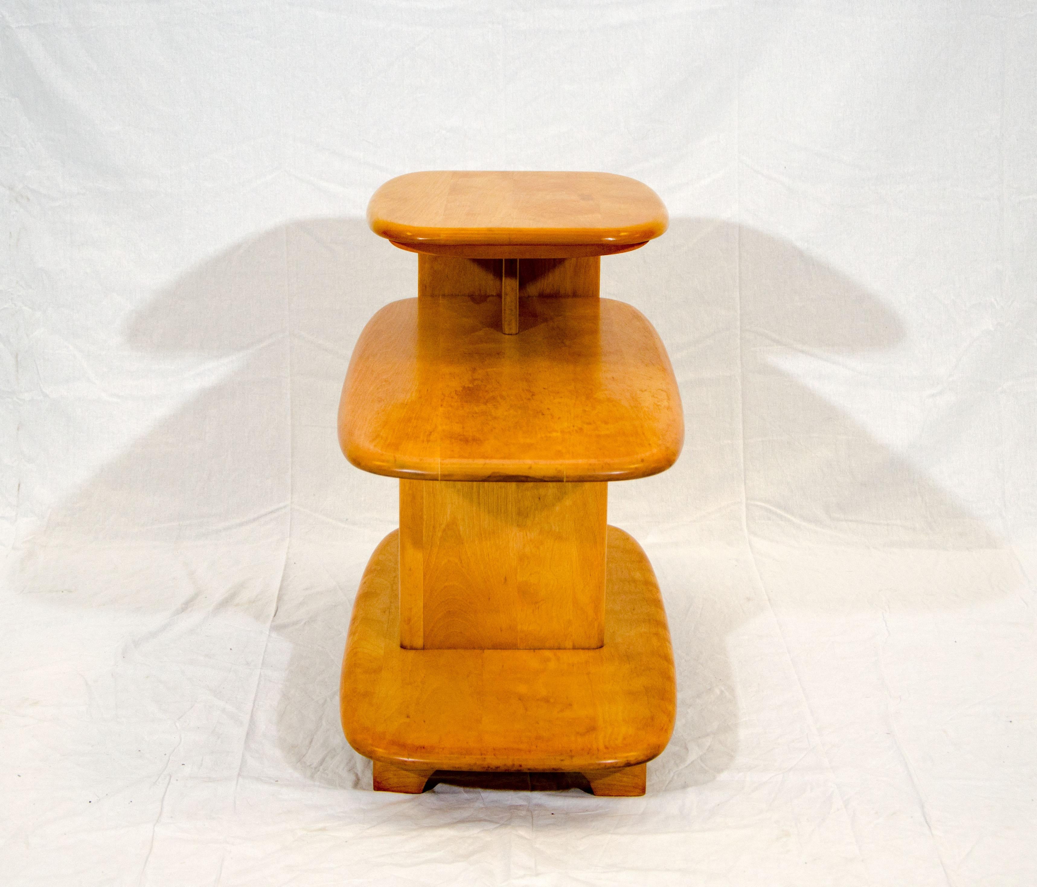 This iconic 3-tier Heywood Wakefield end table was first manufactured in the 1940s. It was discontinued and re-introduced for California production only on in the 1950s. The small top tier measures 14 1/2