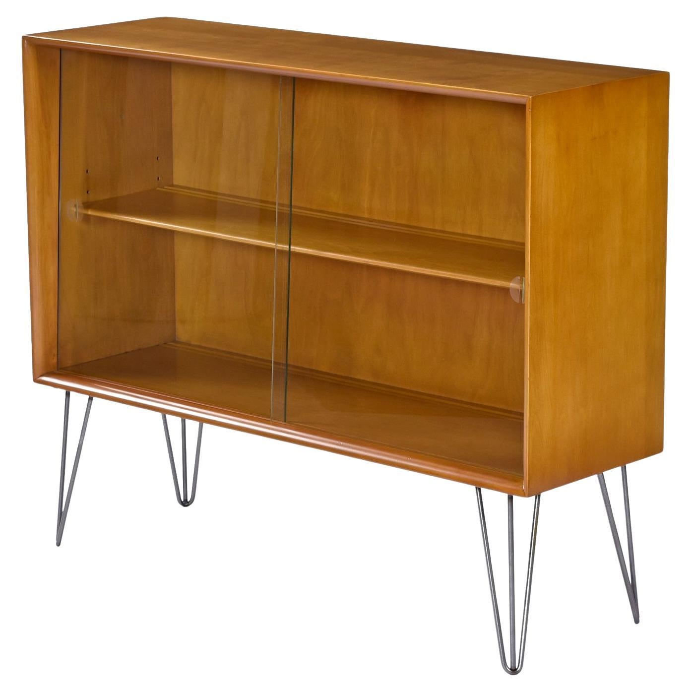 Our shop elevated (literally) this Incredibly versatile Heywood Wakefield display hutch bar with a sleek set of 12