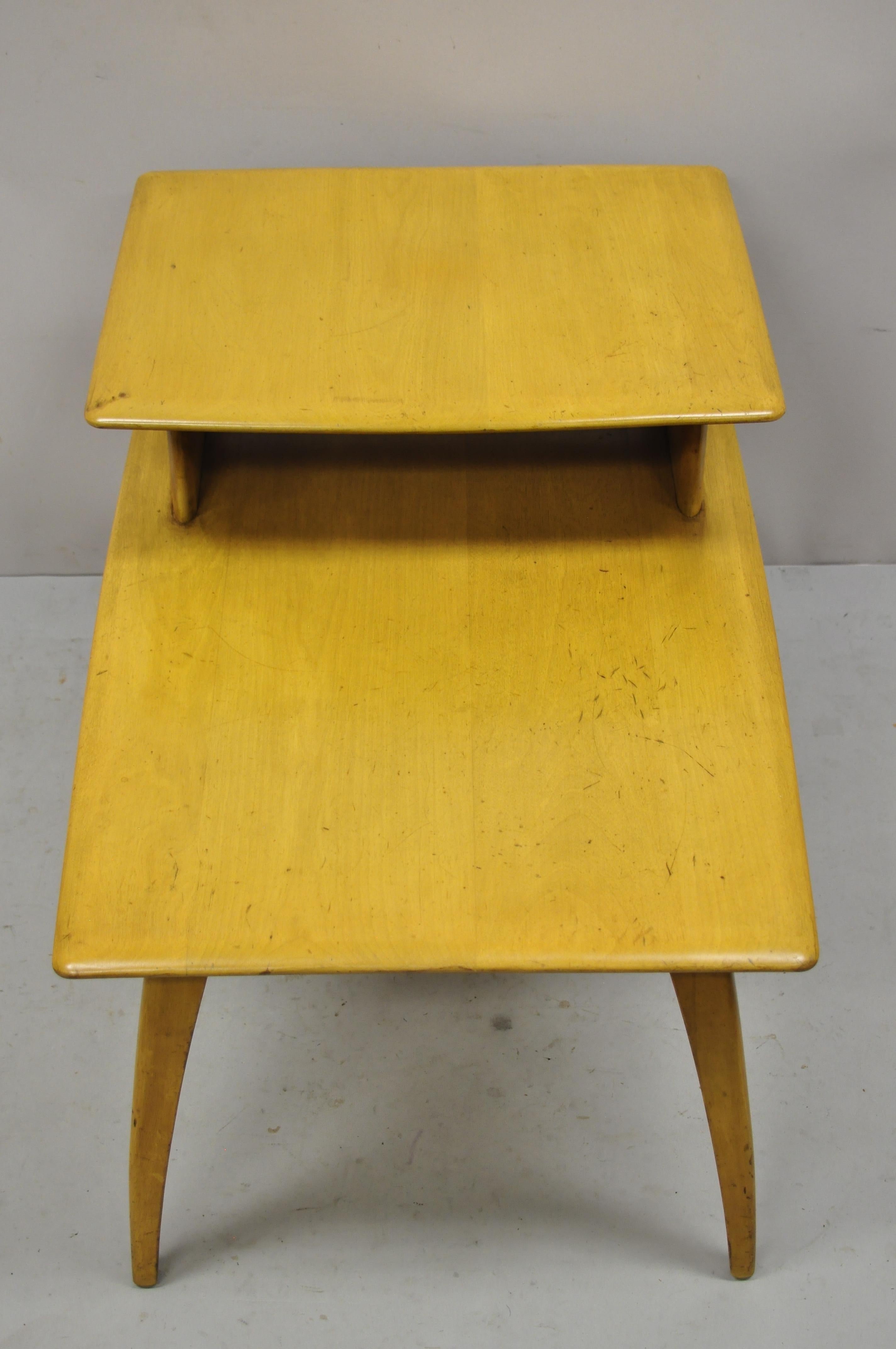 Heywood wakefield wheat Mid-Century Modern birch maple step end table. Item features 2 tiers, solid wood construction, beautiful wood grain, tapered legs, very nice vintage item, quality American craftsmanship, sleek sculptural form. Circa mid 20th