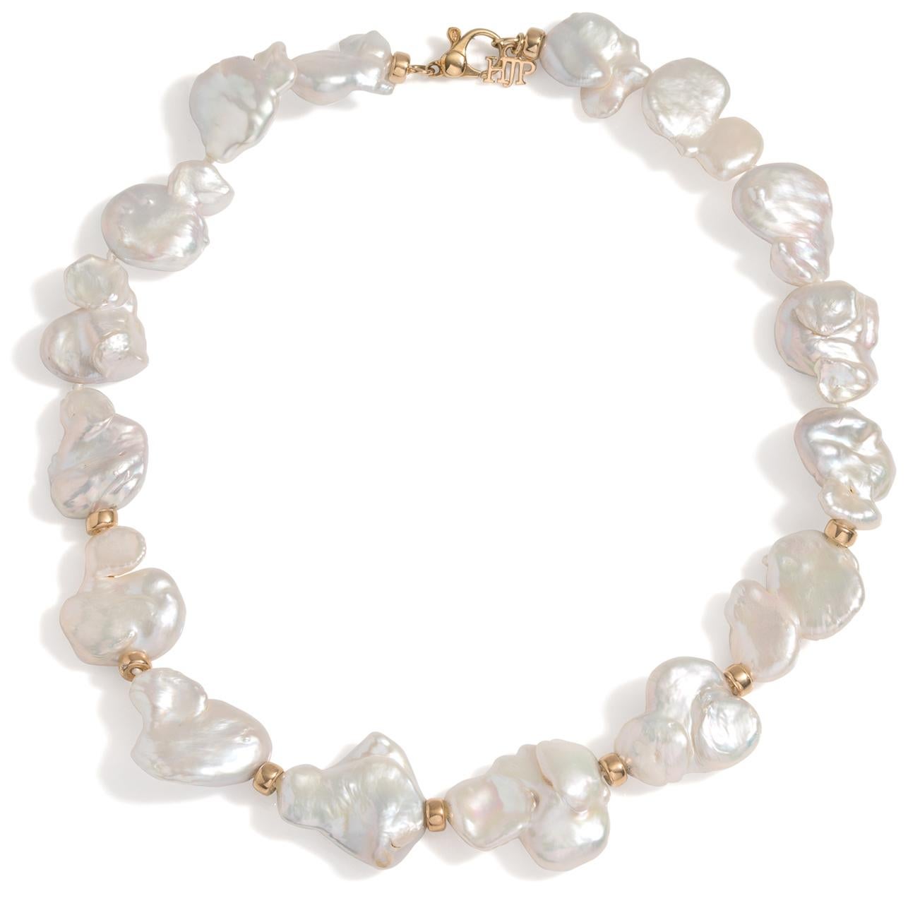 These lustrous Keshi Baroque Pearls lay on the neck like flower petals. Each pearl is knotted and strung with gold bead accents at the front of the strand.

Statement worthy, yet not over the top, this necklace is great as an update to your basic