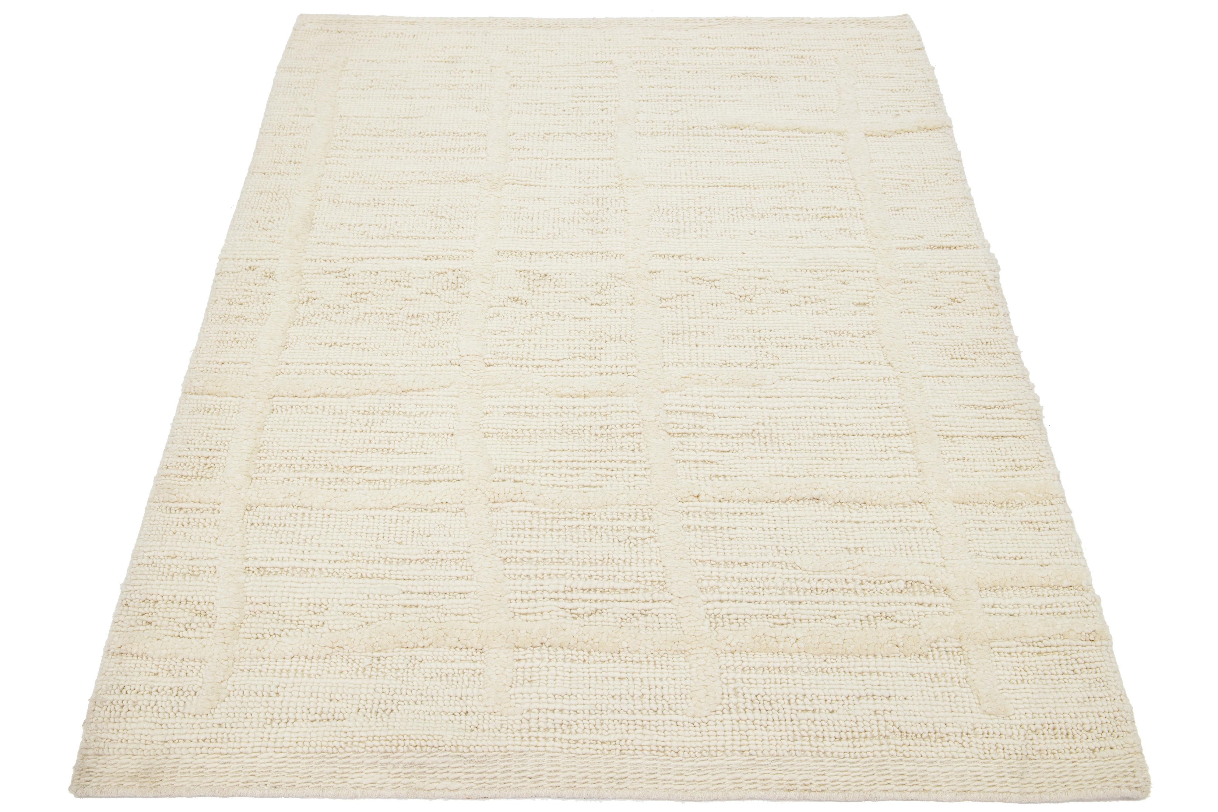 This contemporary Moroccan rug is handcrafted with care and showcases a minimalist and luxurious ivory-tone design.

This rug measures 4'3