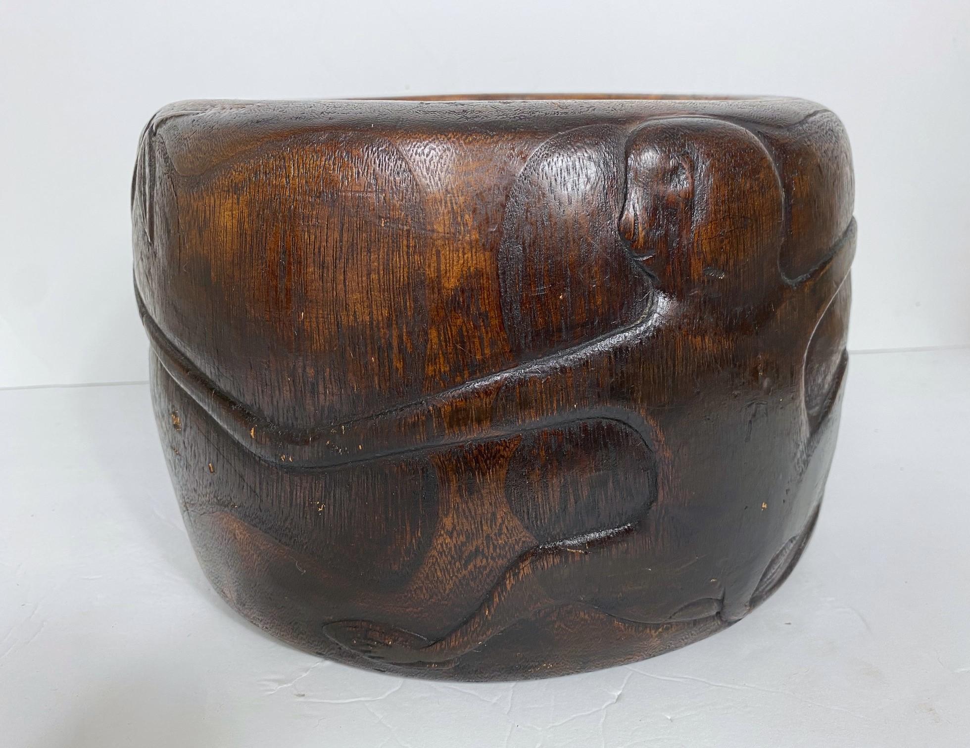 A Hibachi and Paulownia brazier. A carved monkey wrapped around the brazier. Copper liner