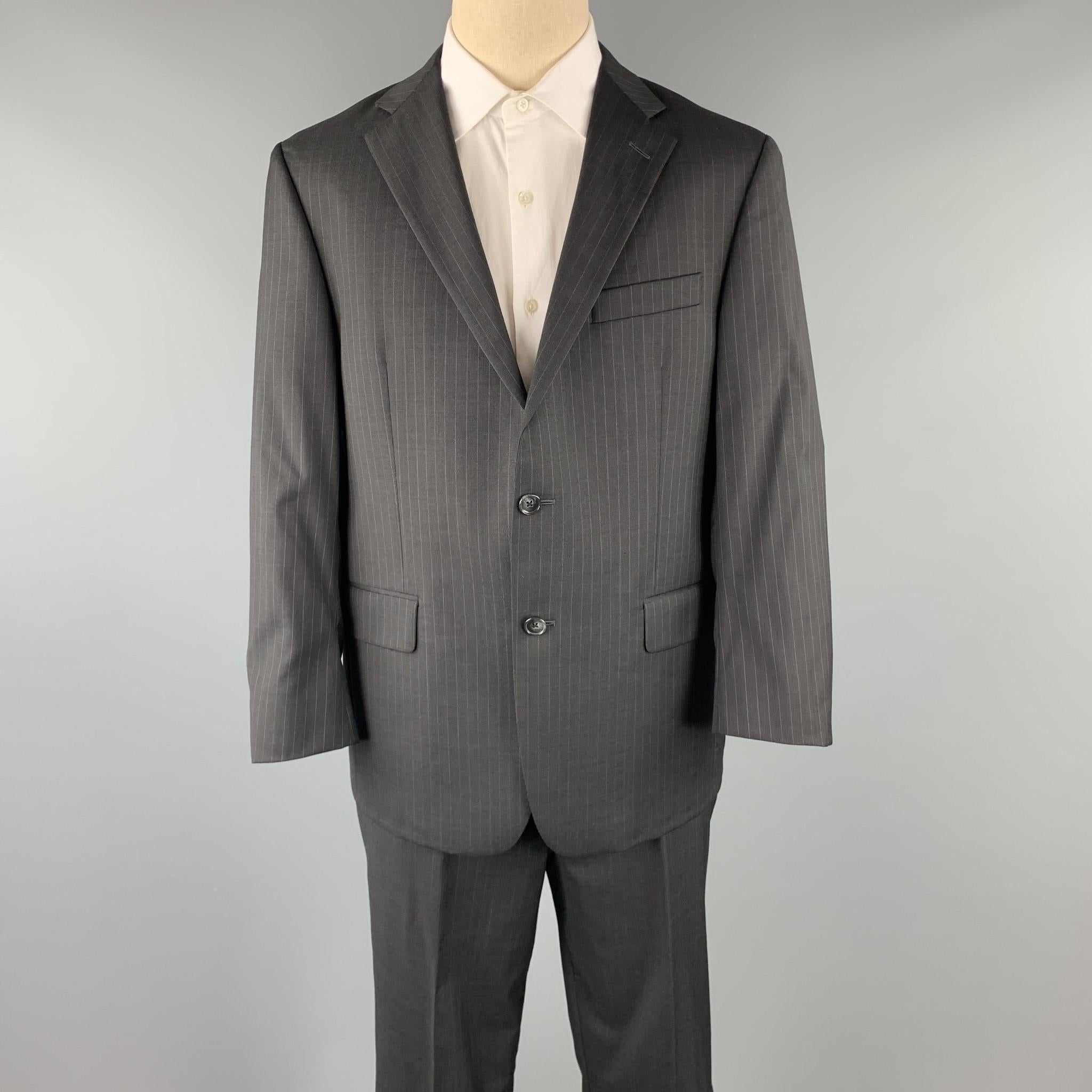 HICKEY FREEMAN suit comes in a black stripe wool and includes a single breasted, two button sport coat with a notch lapel and matching flat front trousers. Made in USA.

Excellent Pre-Owned Condition.
Marked: 42 SHT

Measurements:

-Jacket
Shoulder: