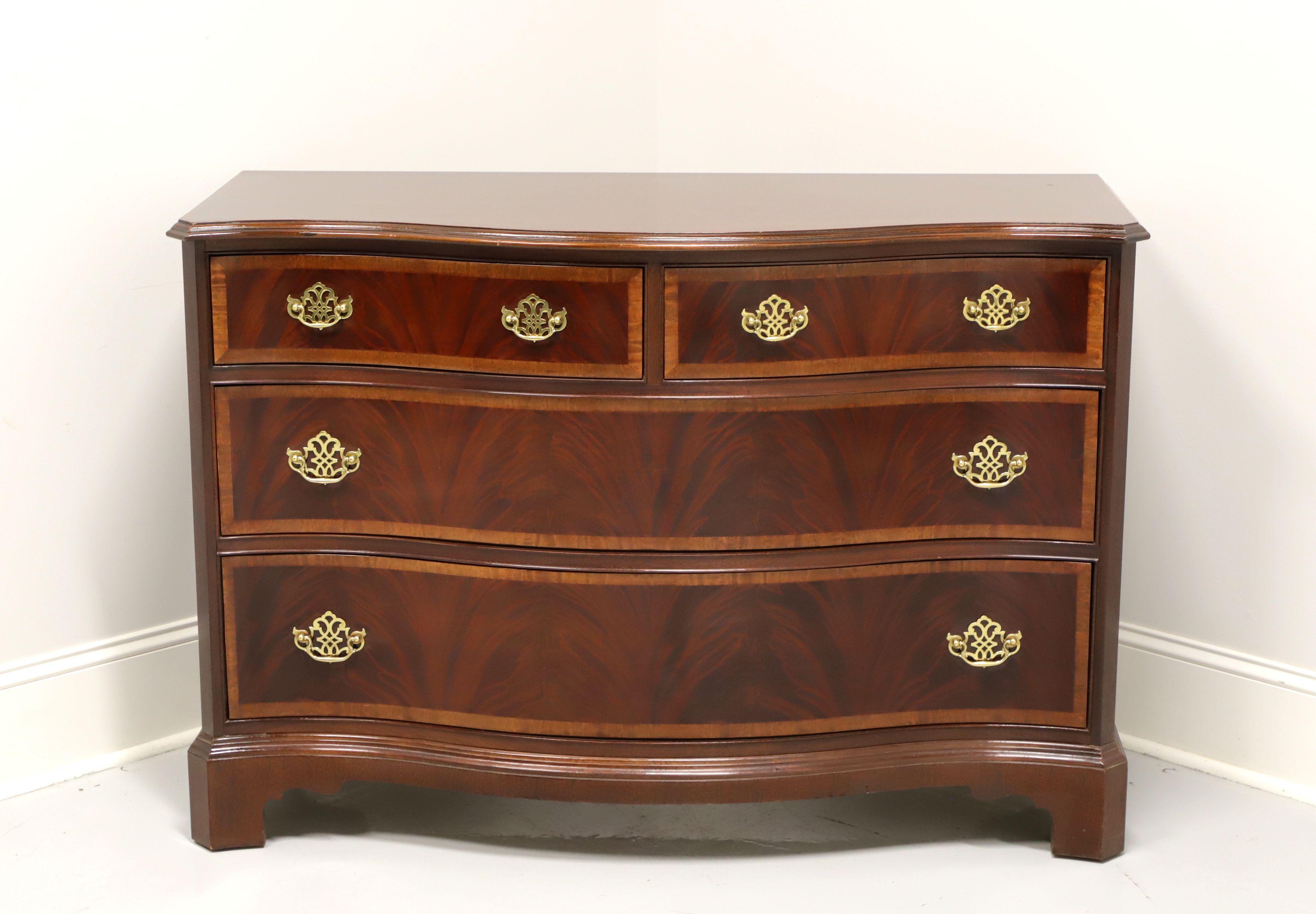 A Chippendale style bachelor chest by Hickory White, from their American Masterpiece Collection. Mahogany with banded drawer fronts, brass hardware and bracket feet. Features two smaller over two larger drawers of dovetail construction. Made in