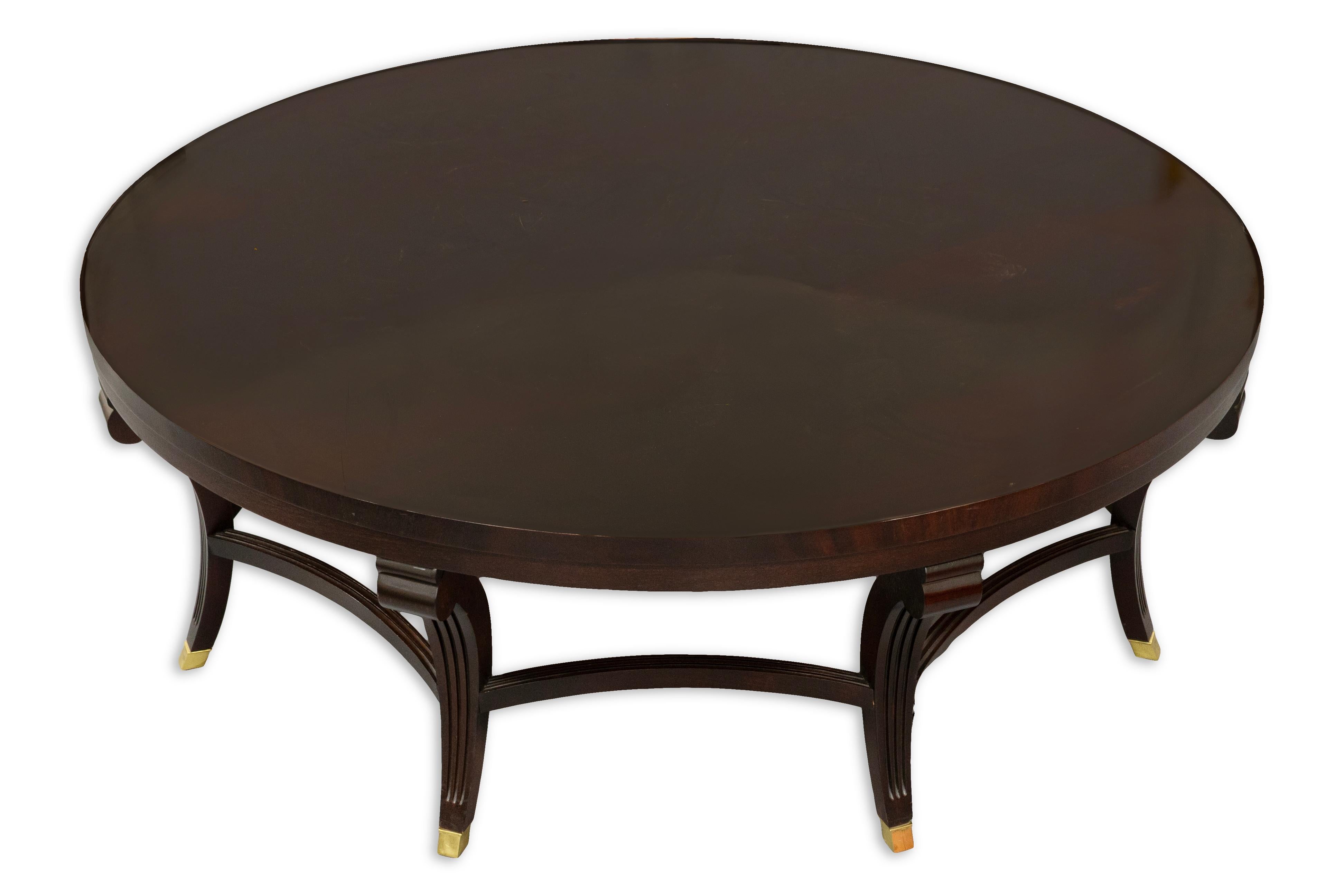 Enhance your living space with the timeless elegance of this mahogany coffee table from Hickory Chair Furniture. Crafted from solid mahogany, the table features a rich, deep finish that highlights the natural grain and luxurious tone of the wood.