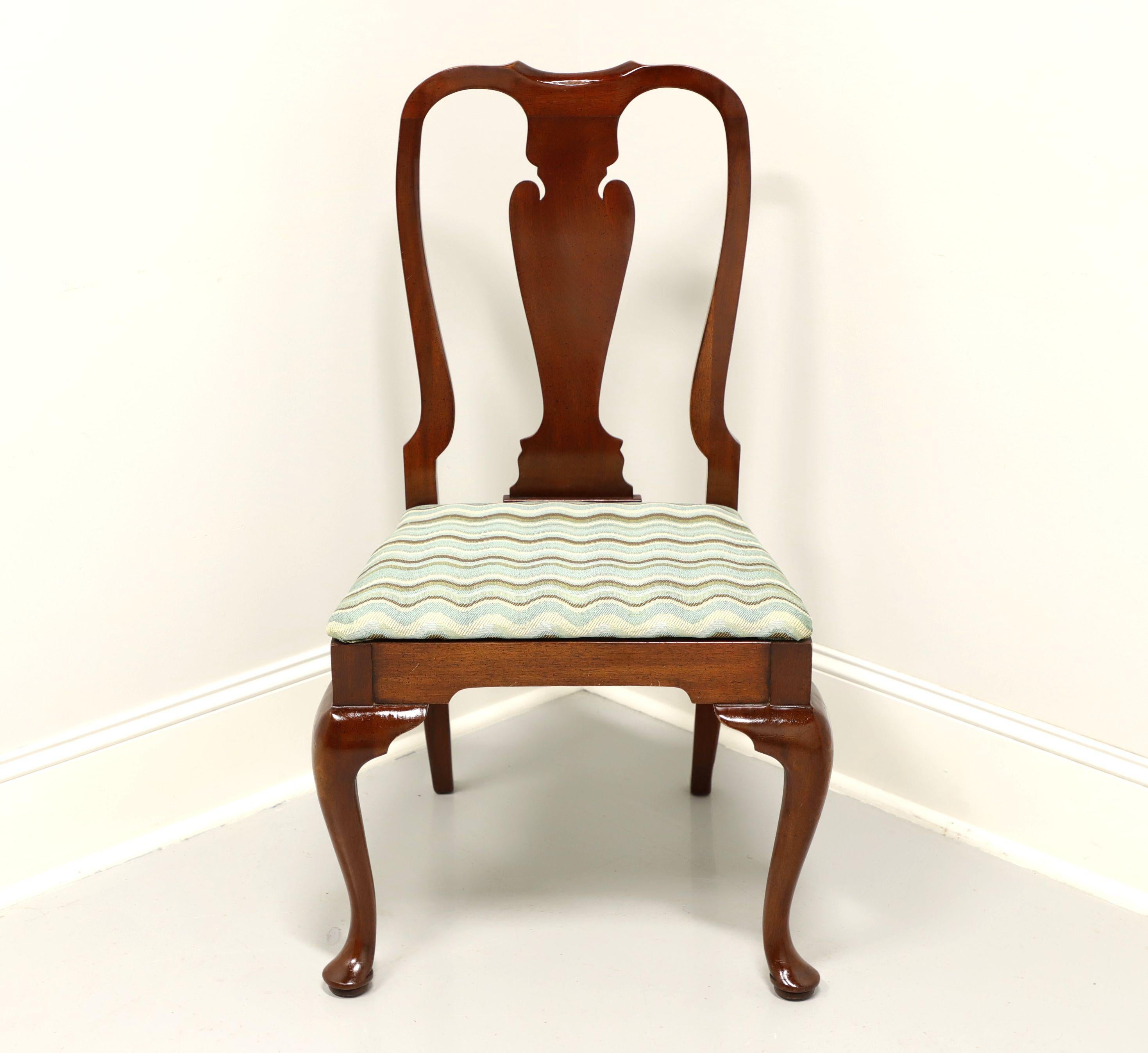 A Queen Anne style dining side chair by top quality furniture maker, Hickory Chair Company. Solid mahogany with their Amber Mahogany finish, carved back rest, blue/brown/cream color wavy pattern fabric upholstered seat, cabriole front legs and pad