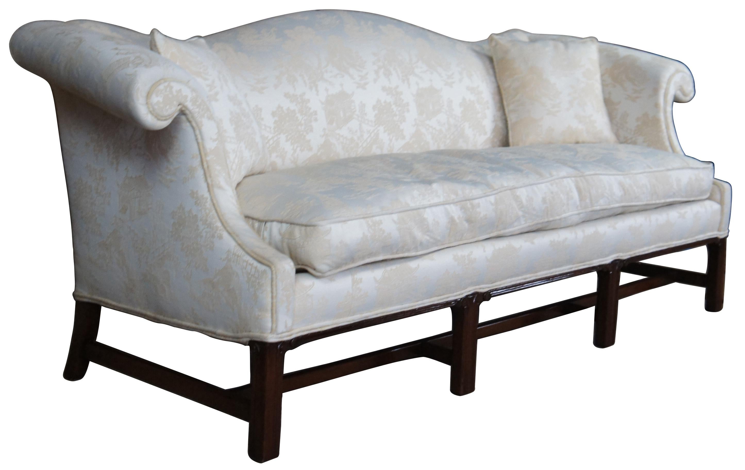 Hickory chair Chippendale Camelback sofa. Made from American Mahogany with rolled arms and fluted straight legs connected by an H stretcher. Upholstered in an off-white pagoda scene with elegant sheen.
 