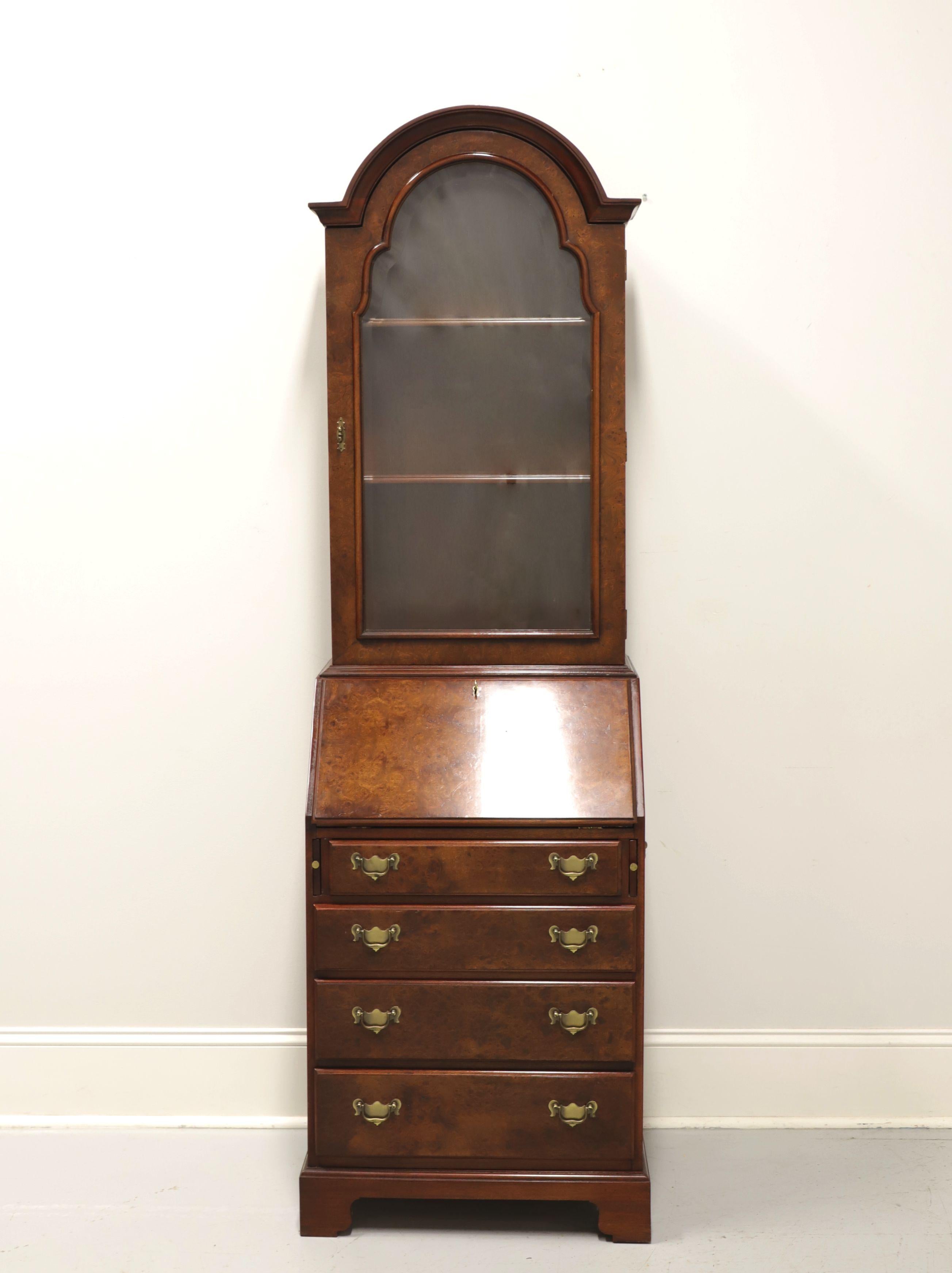 A secretary desk in the Chippendale style by Hickory Chair, from The James River Collection. Burl walnut, brass hardware, single bonnet arched top, slant front and bracket feet. Upper cabinet features two adjustable wood shelves behind a single