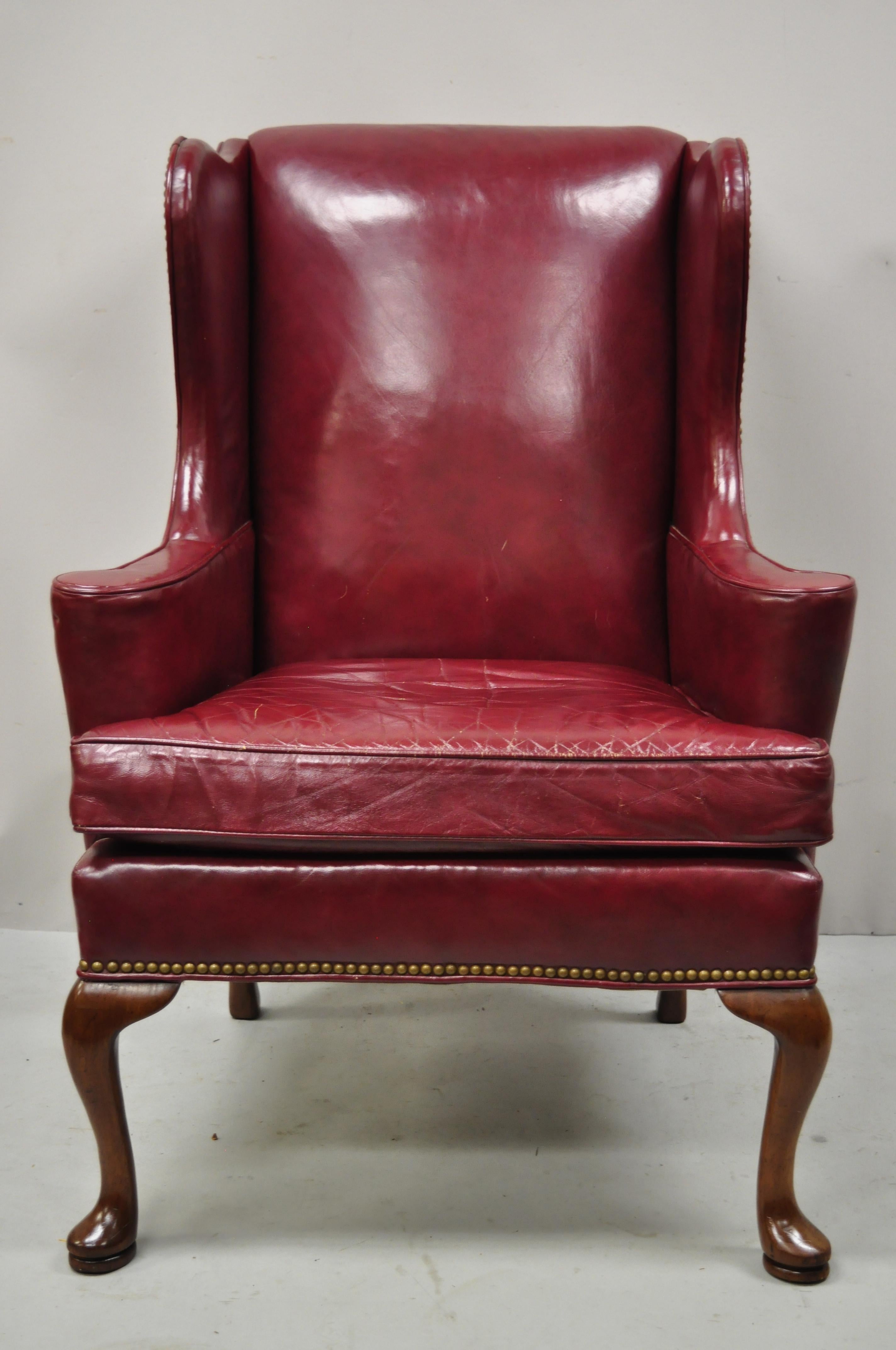 Vintage Hickory Chair Co. Burgundy red leather English Queen Anne Georgian wingback lounge chair. Item features shapely winged back, rolled arms, nailhead trim, quality American craftsmanship, great style and form. Circa mid to late 20th century.