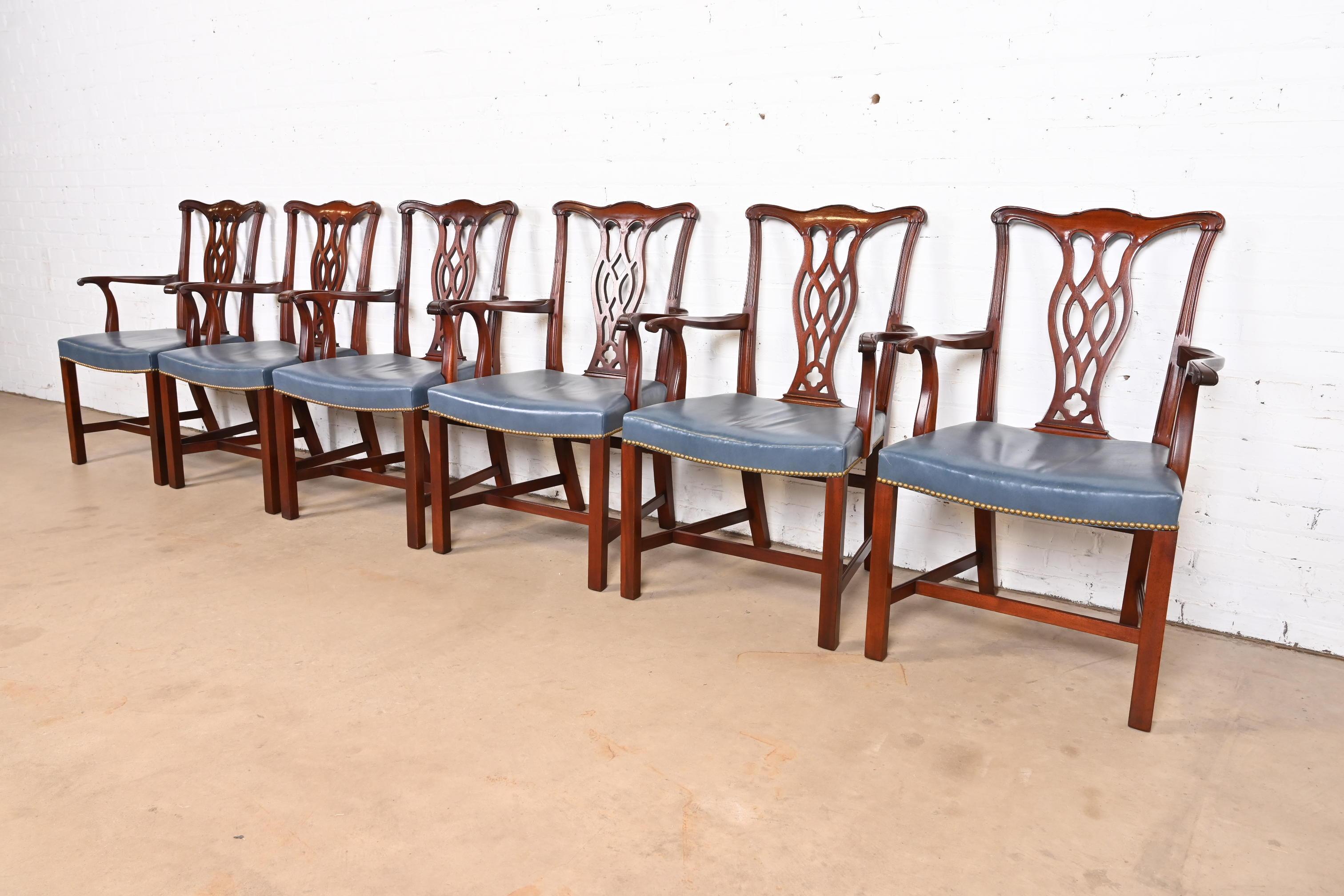 A gorgeous set of six Georgian or Chippendale style dining arm chairs

By Hickory Chair Furniture Co.

USA, Circa 1980s

Carved mahogany, with brass studded blue leather seats.

Measures: 24.25