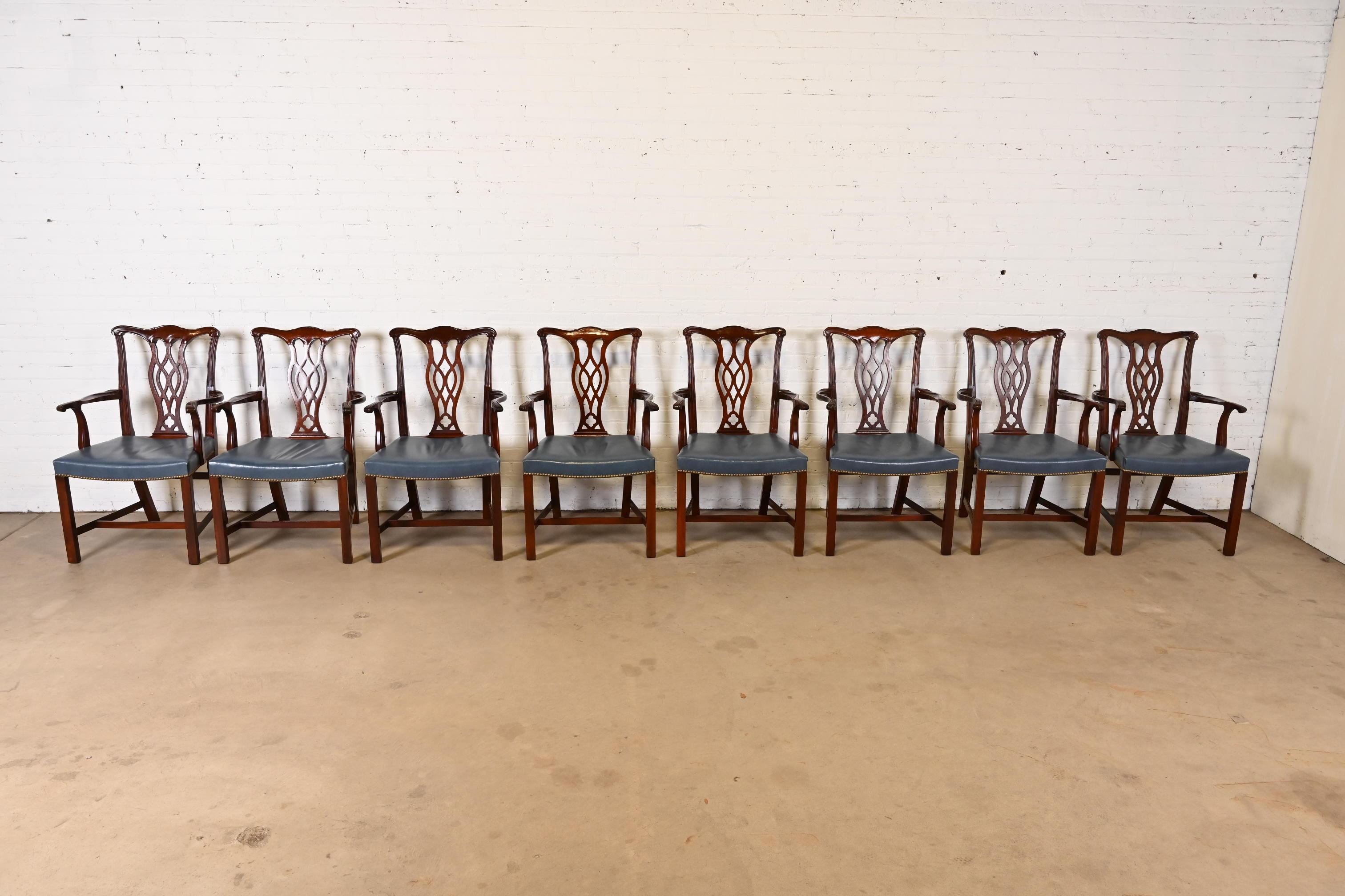 A gorgeous set of eight Georgian or Chippendale style dining arm chairs

By Hickory Chair Furniture Co.

USA, Circa 1980s

Carved mahogany, with brass studded blue leather seats.

Measures: 24.25
