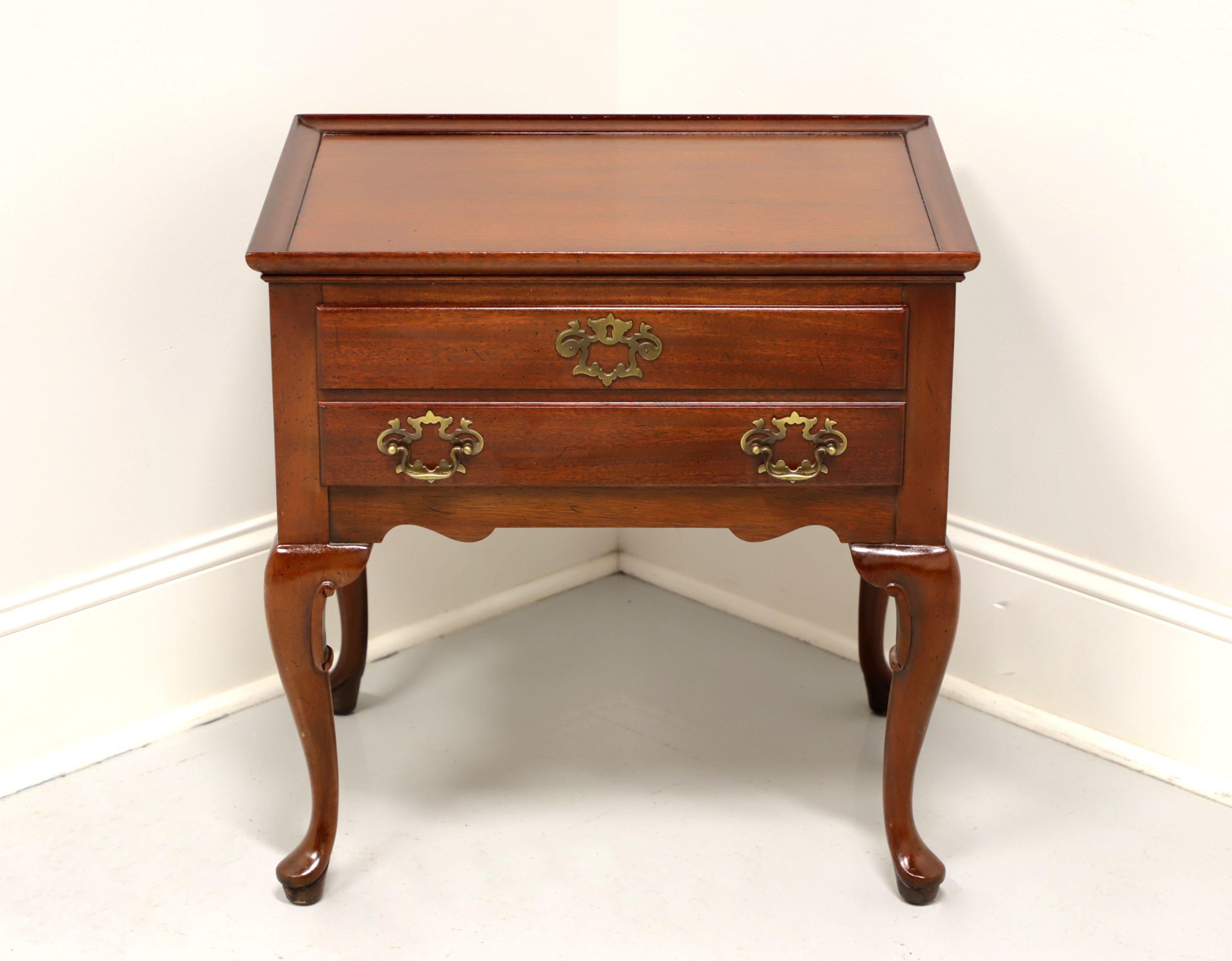 A Queen Anne style nightstand or accent side table by Hickory Chair, from their James River Collection. Solid mahogany with brass hardware. Features one dovetail drawer with faux keyhole escutcheon, tapered legs and pad feet. Made in the USA, in the